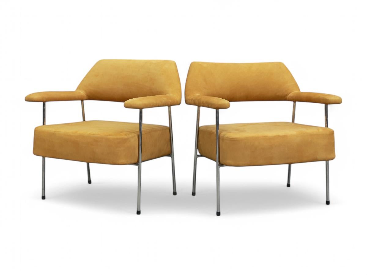 These armchairs by Joaquim Tenreiro are nothing less than specatcular.

The structure of these two chairs is made with painted tubular metal. It features a mustard suede upholstery. The iron has been repainted and refinished and the seats have been