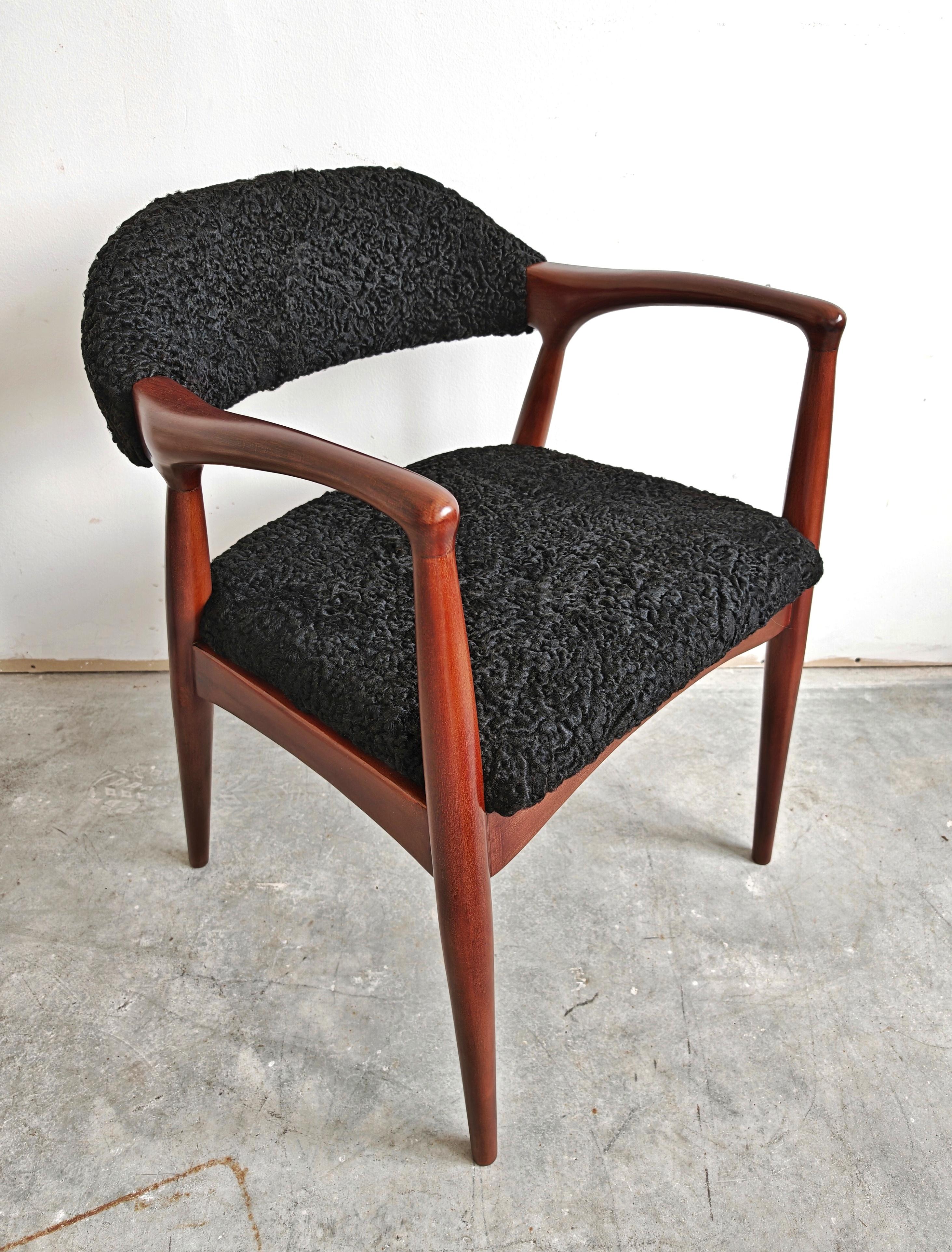 In this listing you will find a sleek and exceptionally stylish Mid Century Modern armchair done in beech and upholstered in astrakhan, combining perfectly the black curly astrakhan fur with the brown/redish stain of the wood. It gives a luxurious