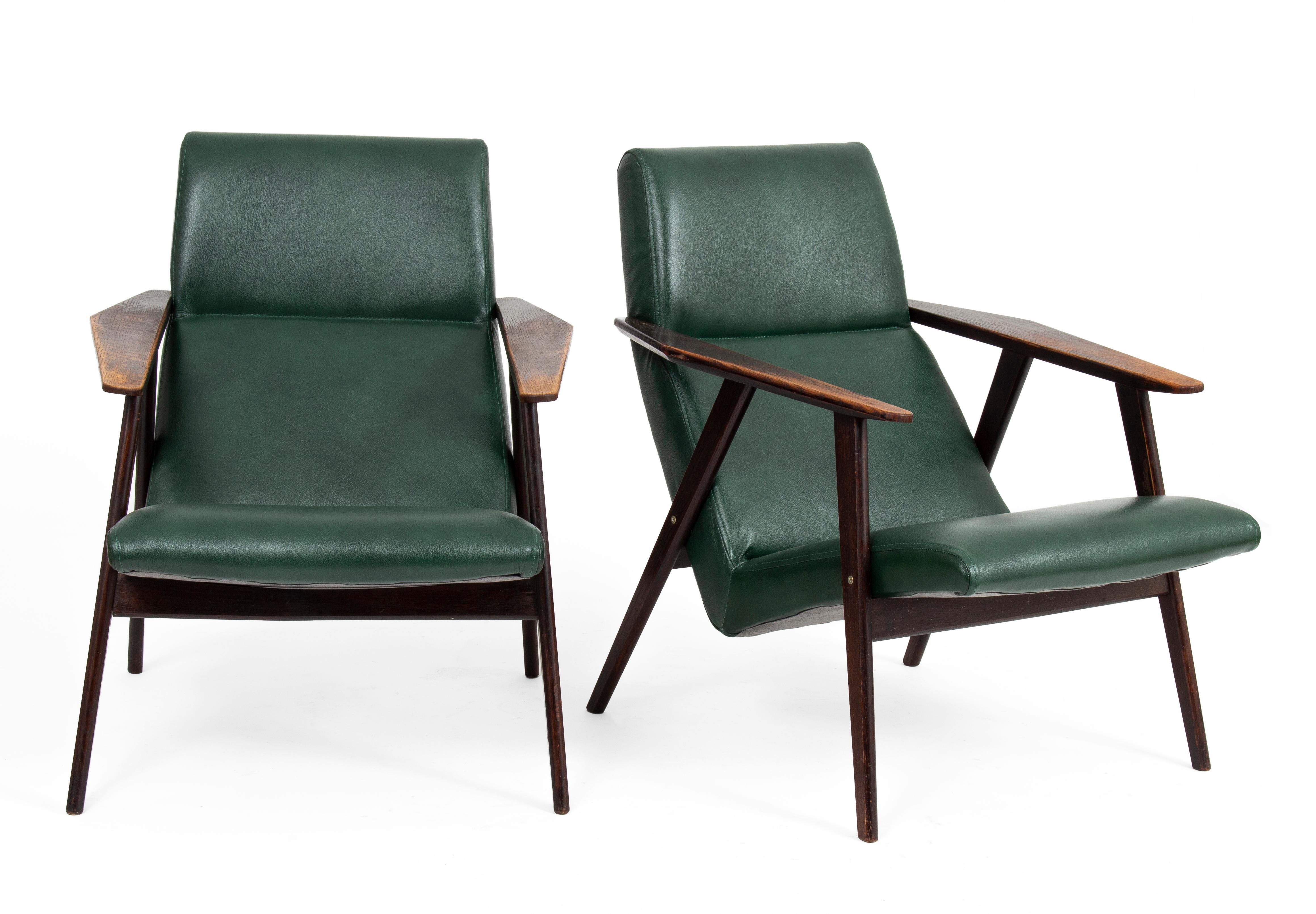 Mid-century modern armchairs in pairs from the 1960s.

The original solid and comfortable structure has been honored with a new dark green leather upholstery. The elegant yet funky design fits modern and contemporary interiors.

