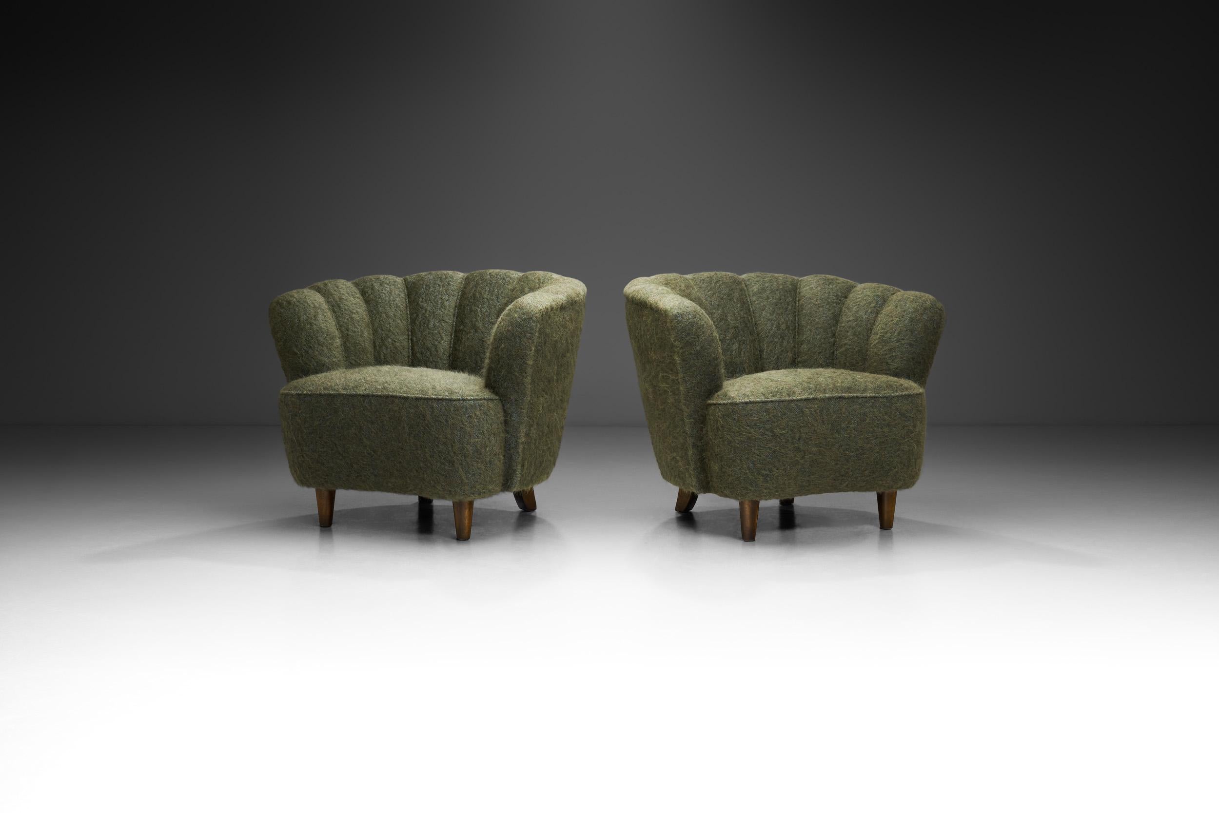 Quelques sièges exceptionnels ont vu le jour dans les années 1950, incarnant des éléments élégants du passé et faisant appel à des éléments décoratifs. Avec leur dossier festonné caractéristique, ces chaises de salon exsudent l'esprit de l'époque et