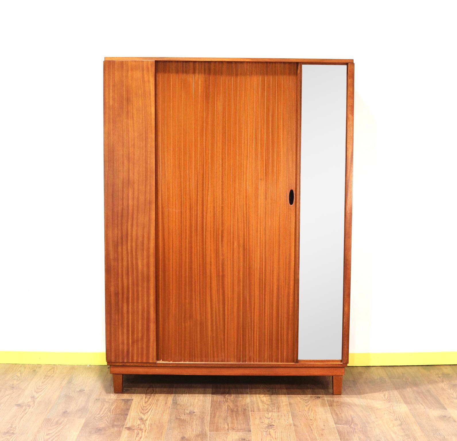 A fantastic example of mid century style. This fantastic armoire by British furniture maker, Austinsuite would take pride of place in any bedroom. The tambour door is a really eye catcher and the mirror is a useful add on.