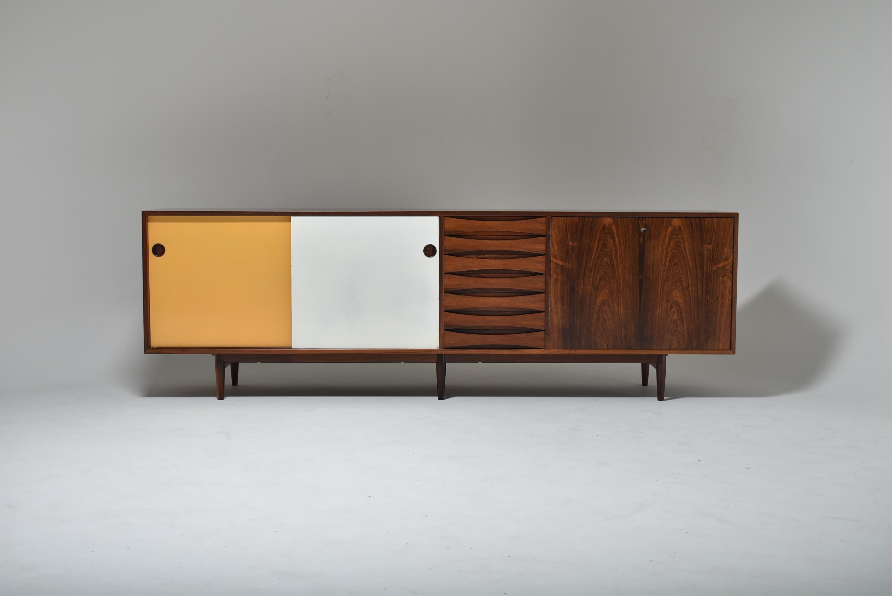 Santos Rosewood “29 A” Sideboard by Arne Vodder for Sibast, also refered as Triennale, Denmark, late 1950s.
This iconic piece of furniture was designed by Arne Vodder for Milan's triennale fair in 1969. 
Freestanding Santos rosewood sideboard on six