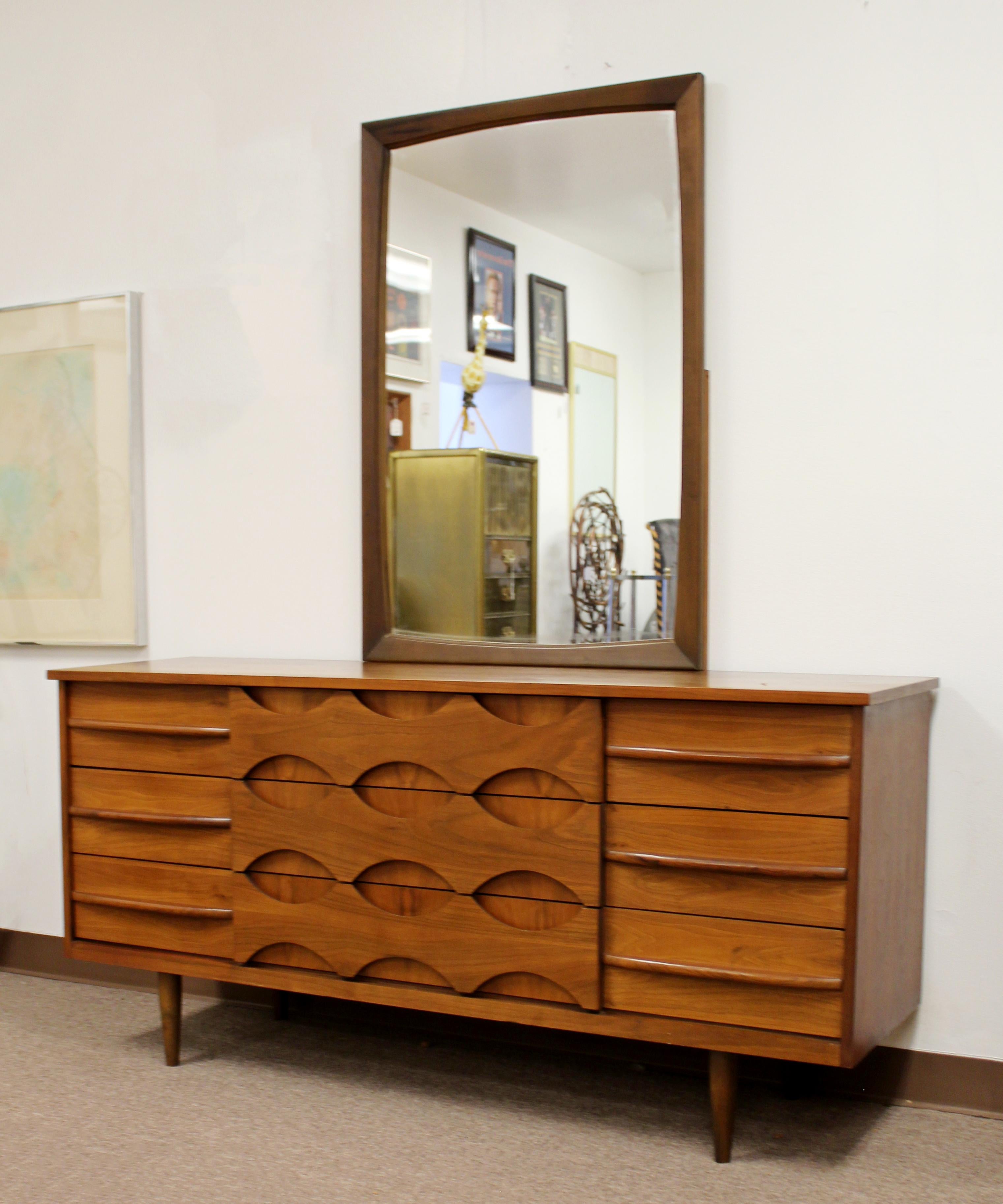 For your consideration is a stupendously carved, pair of walnut dressers, one with an attached mirror, made in Denmark, in the style of Arne Vodder, circa the 1960s. In excellent vintage condition. The dimensions of the highboy are 38