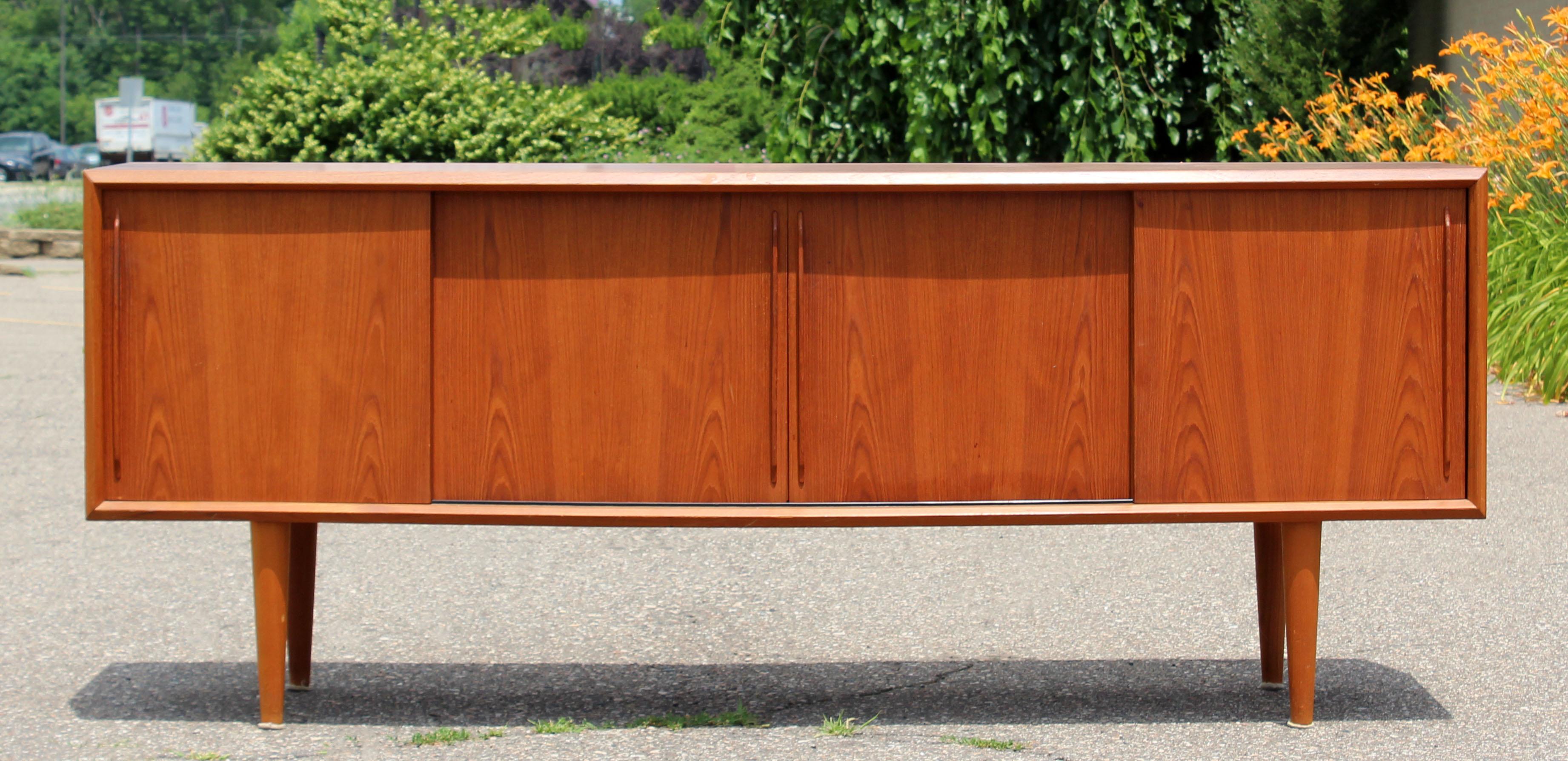 For your consideration is a magnificent, teak credenza with four shelves and four drawers by Arne Vodder for H.P. Hansen, made in Denmark, circa 1960s. In very good condition. The dimensions are 79