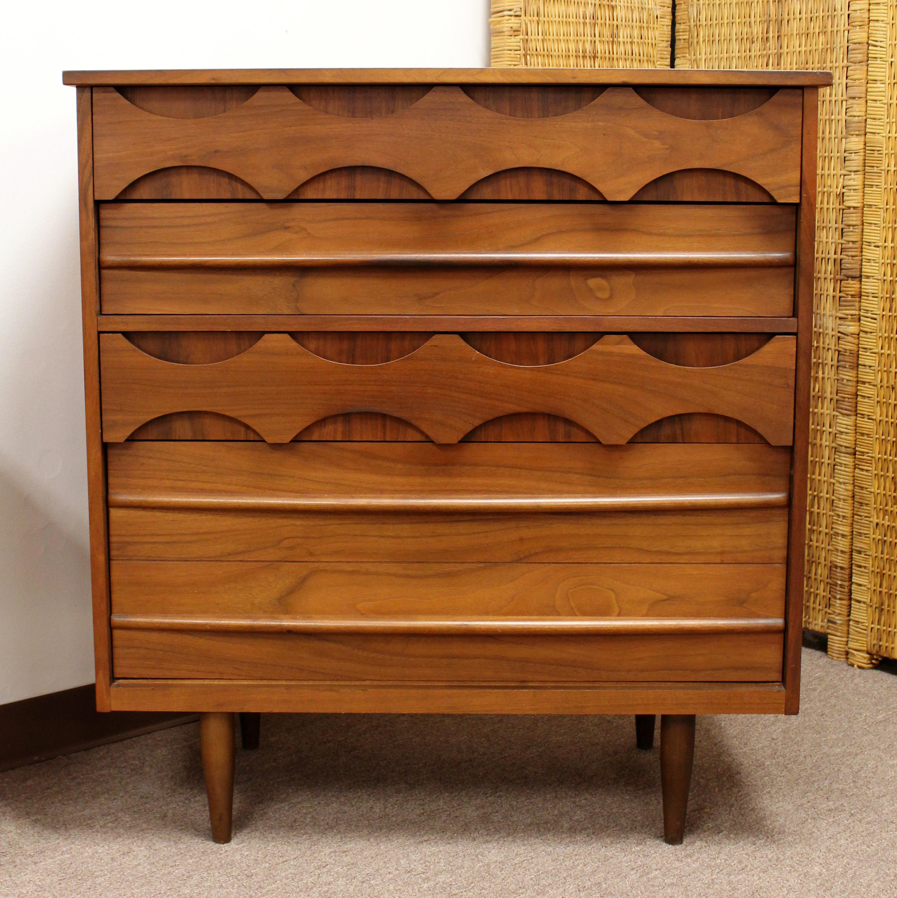 For your consideration is a delightfully carved, four drawer, highboy dresser, made in Denmark, in the style of Arne Vodder, circa 1960s. In excellent vintage condition. The dimensions are 38