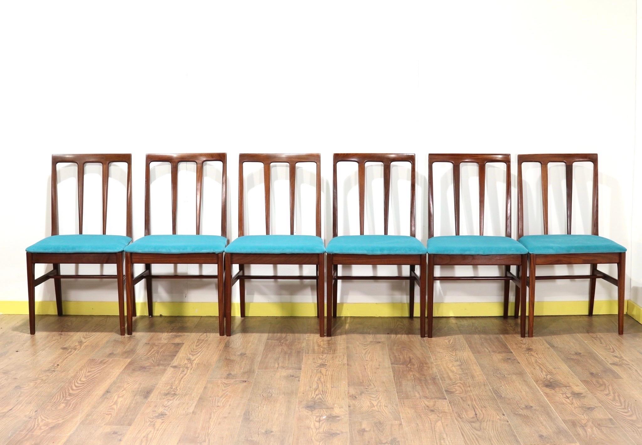 A fantastic set of 6 dining chairs by British furniture maker, A Younger. The frames are made from Afromosia and the pads have been recently coverded in teal material that give the chairs a stunning look.