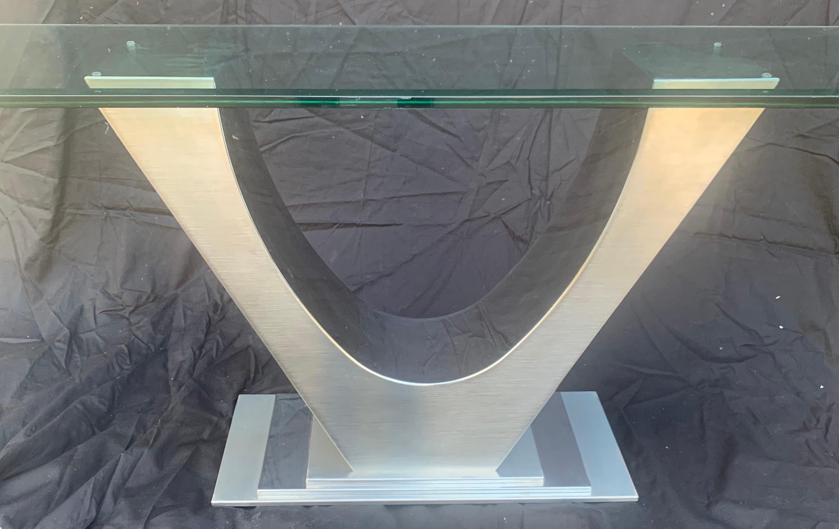 A wonderful Mid-Century Modern Art Deco polished and brushed nickel beveled glass top U-shaped console table.