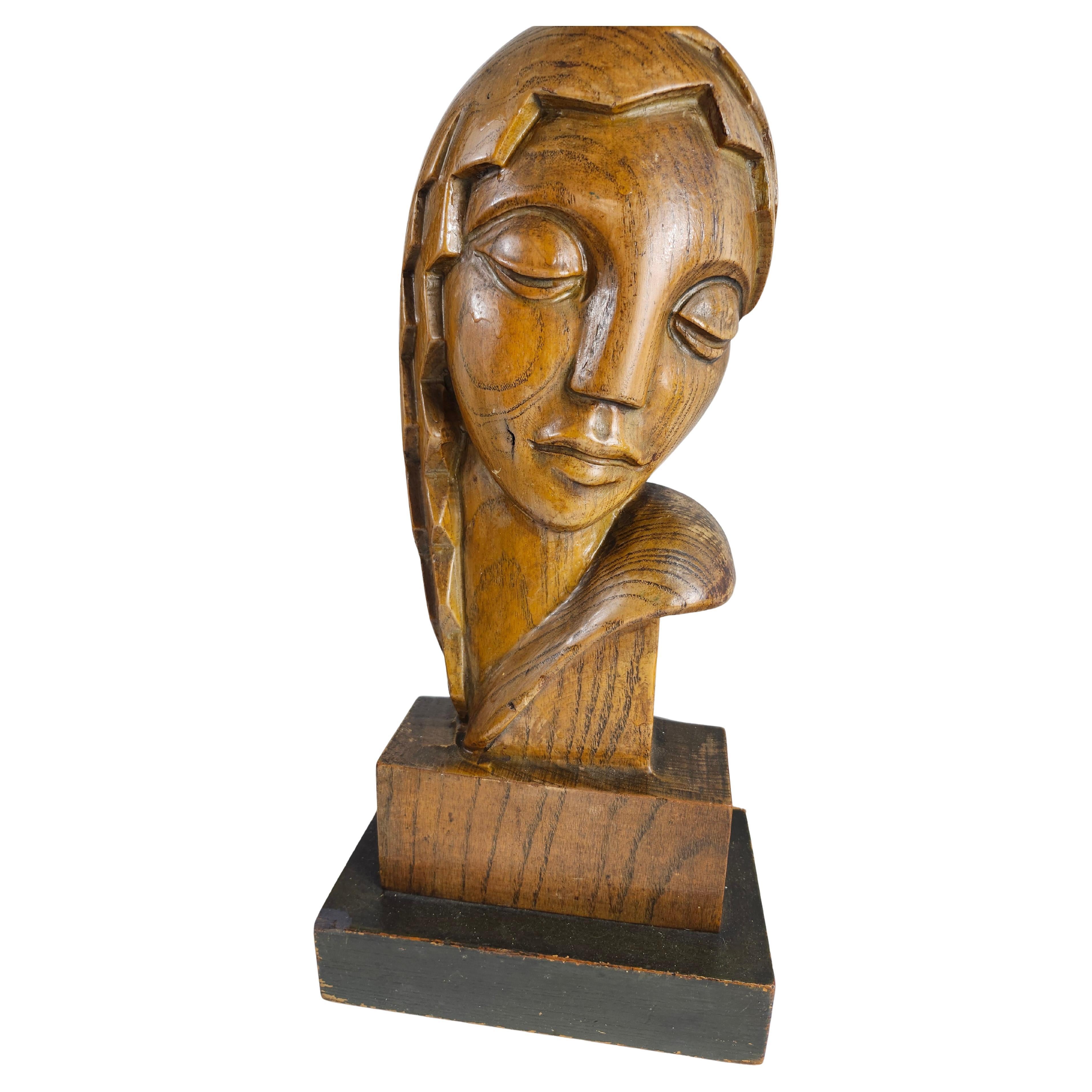 Fabulous pair of Mid Century Modern Sculptural Table Lamps in carved oak . Ladies heads in a stylized Art Deco manner. We'll executed and sitting on black plinths for maximum significance.  Entirely new wiring, a double cluster for a possible