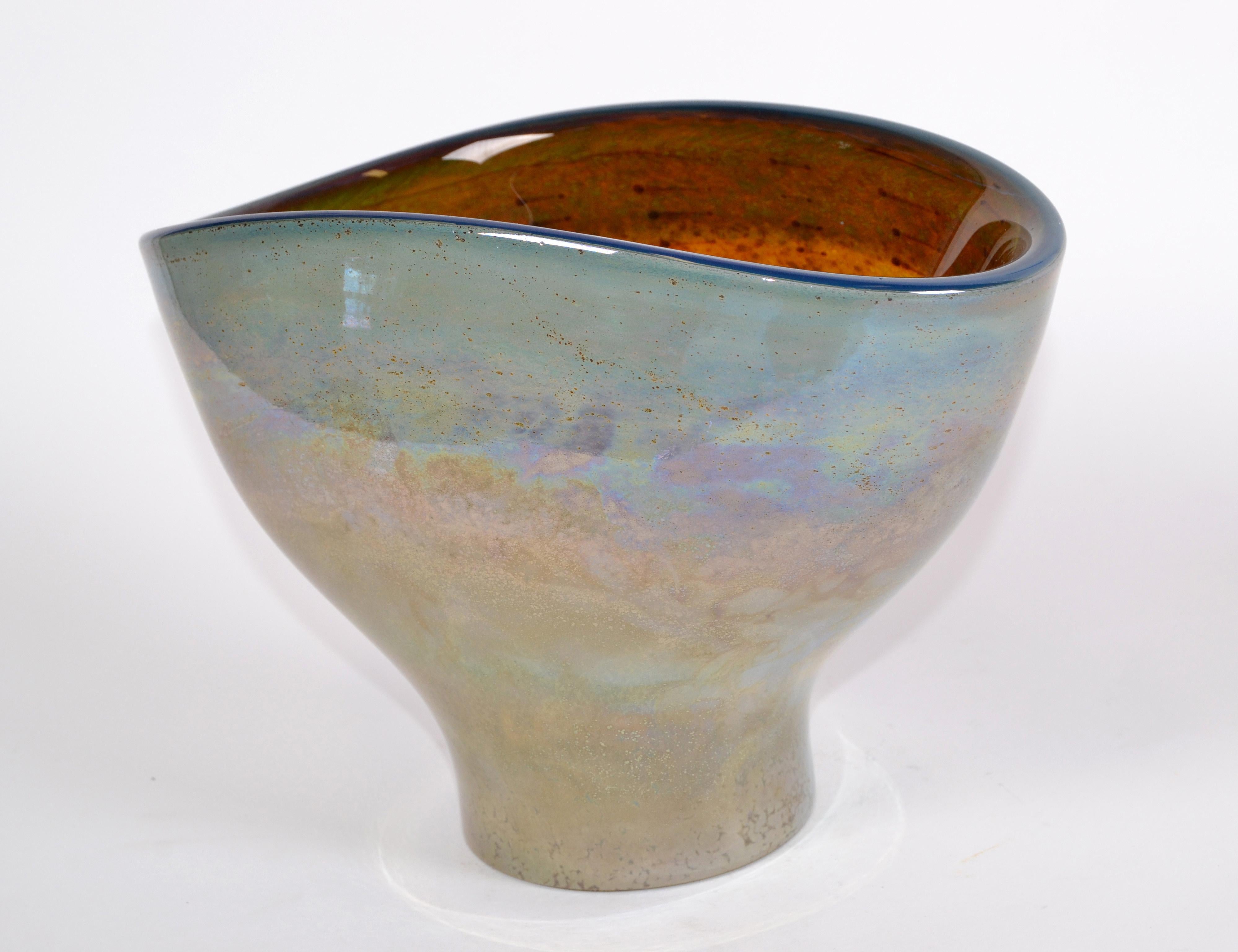 Heavy beautiful art glass bowl in hues of green, blue and bronze dust.
Marked with label, made in Poland.