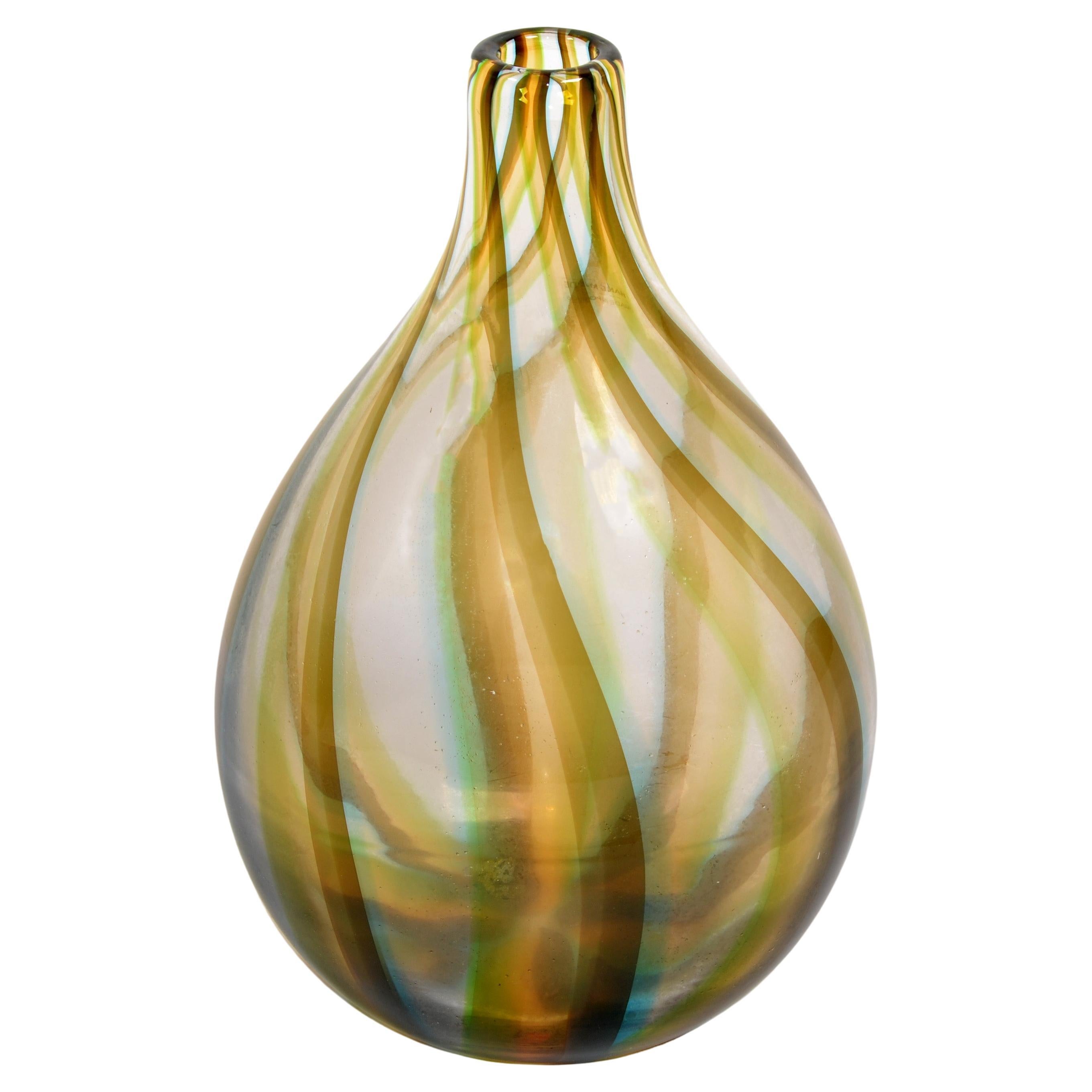 Heavy beautiful art glass Vase in hues of Amber, Blue and Bronze Color Swirl Design.
Mid-Century Modern Period styled after Venini Glass Studio.
Marked with label, made in Poland.
In good condition, no chips or cracks.
Opening measures 1.25 inches.