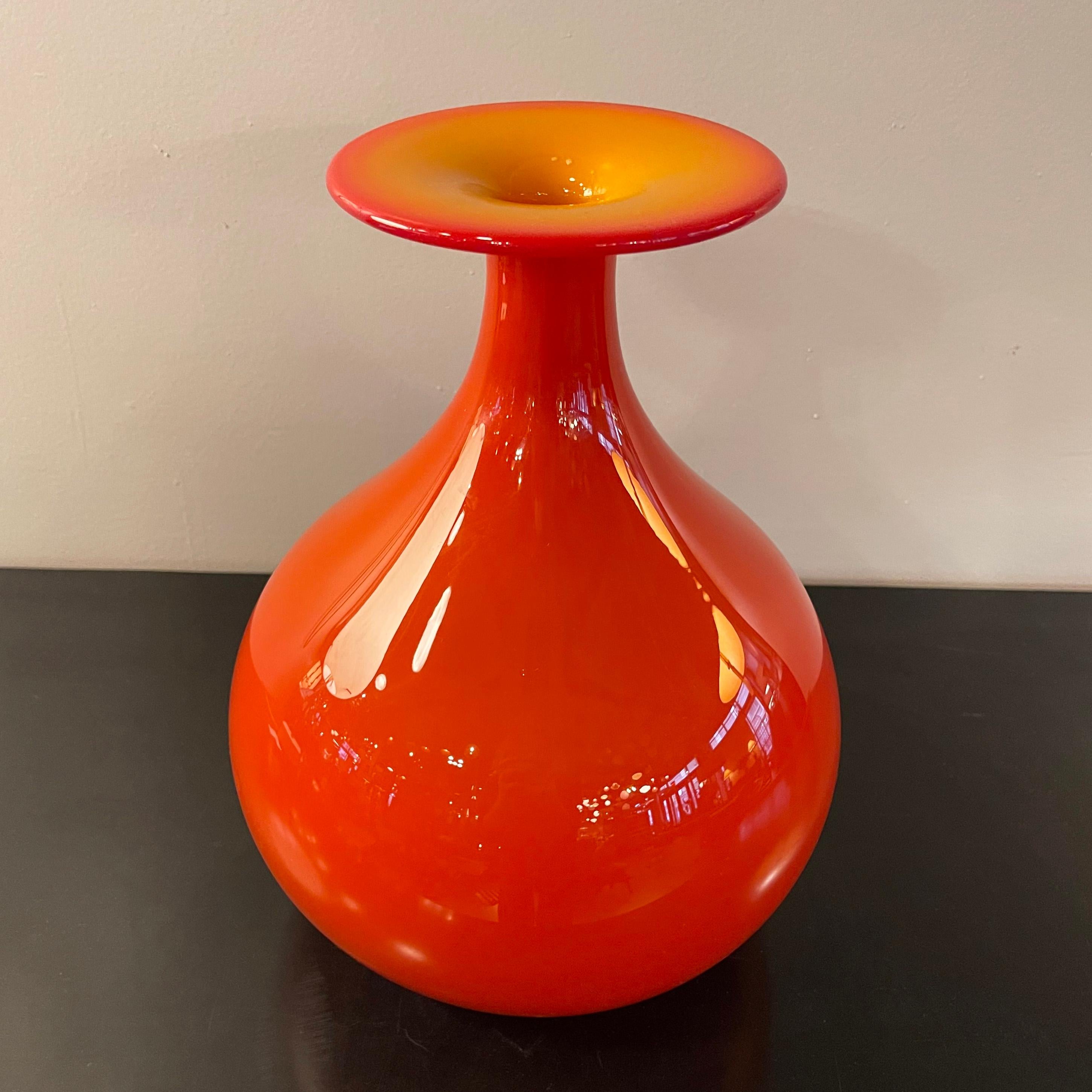Mid century modern, art glass vase by Tom Connally for Greenwich Flint Craft in brilliant, opaque orange with contrasting orange ochre top. The mouth opening measures 1 inch.