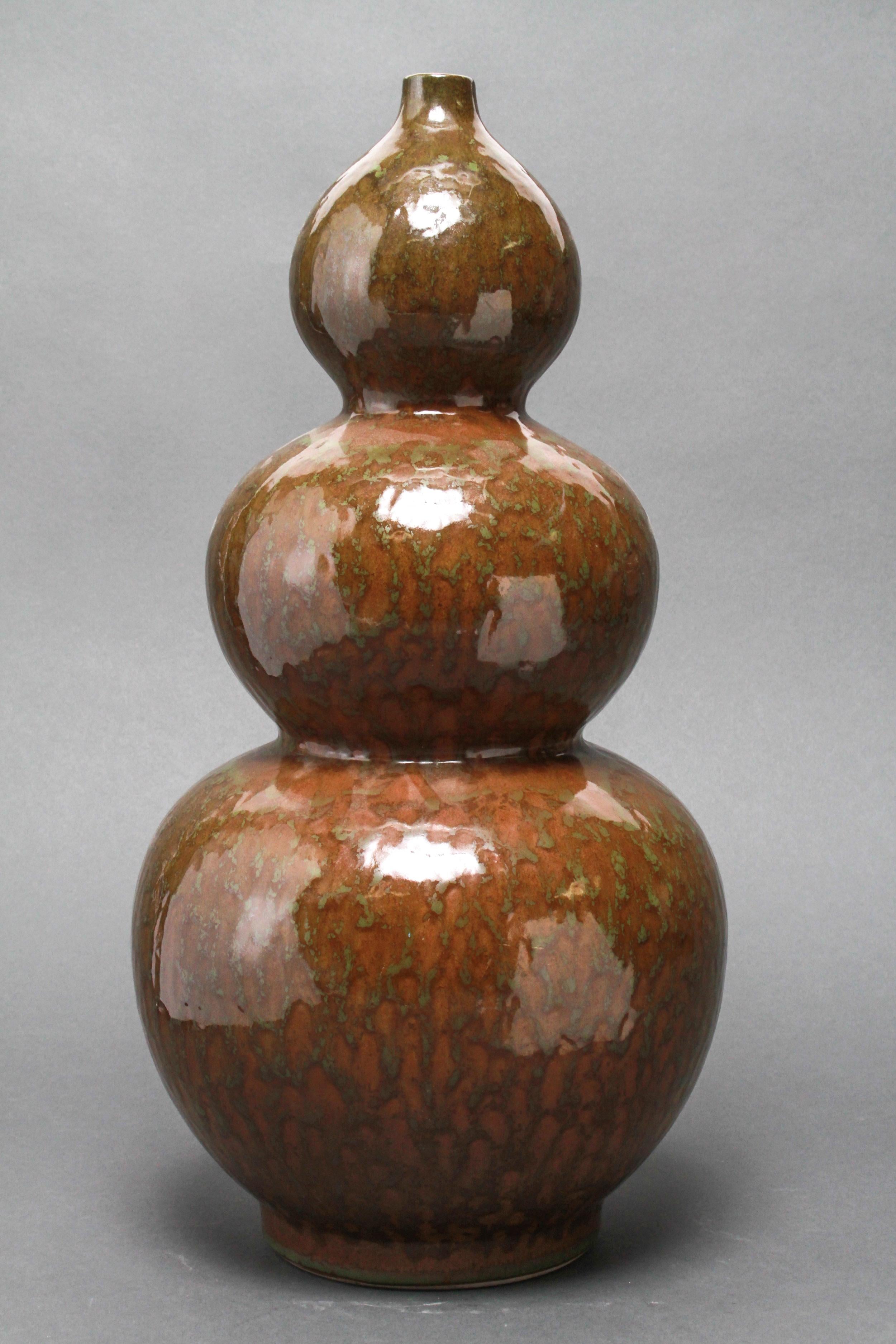 Mid-Century Modern triple gourd shaped art pottery vase with a green and brown glaze. The piece is in great vintage condition with age-appropriate wear.
