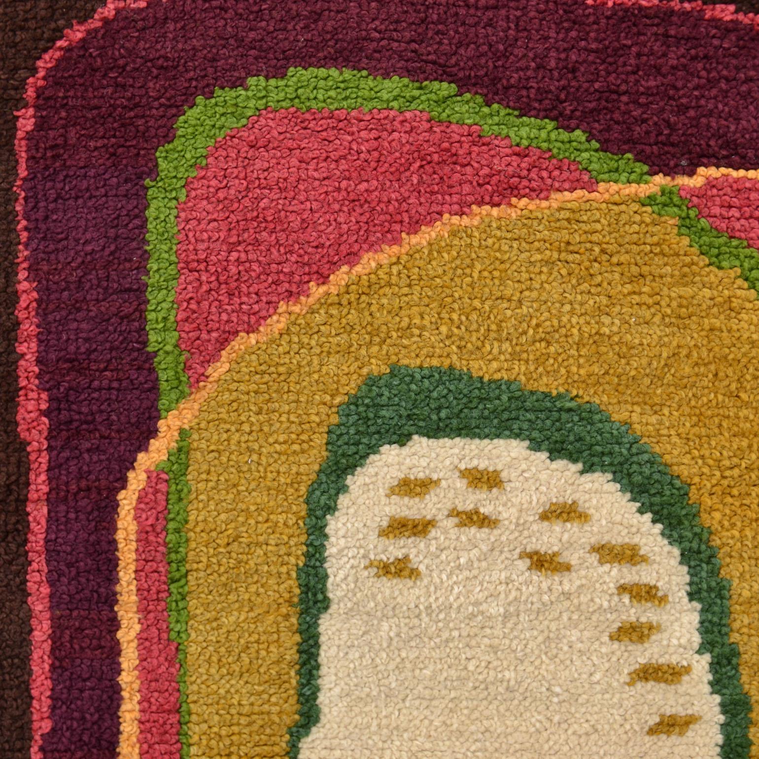 Mid-Century Modern wool hand tufted pile rug is like an abstract expressive painting of circular overlapping swirls of changing colors, Europe circa 1950. The ingenious color variations create a strong counter change pattern of curvaceous shapes.