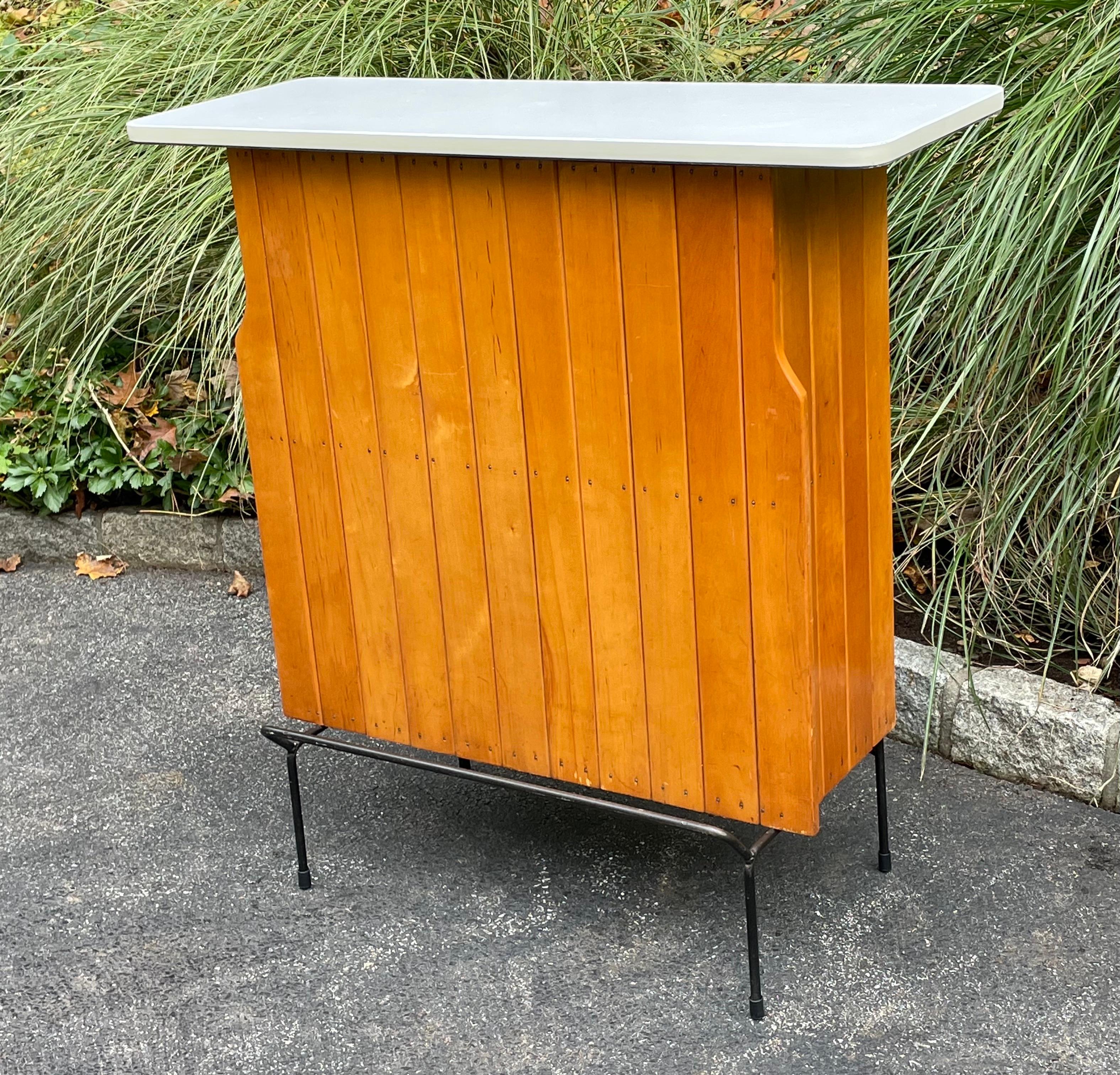 Very cool dry bar console by Arthur Umanoff, freshly painted white top with vintage side bottle top opener.