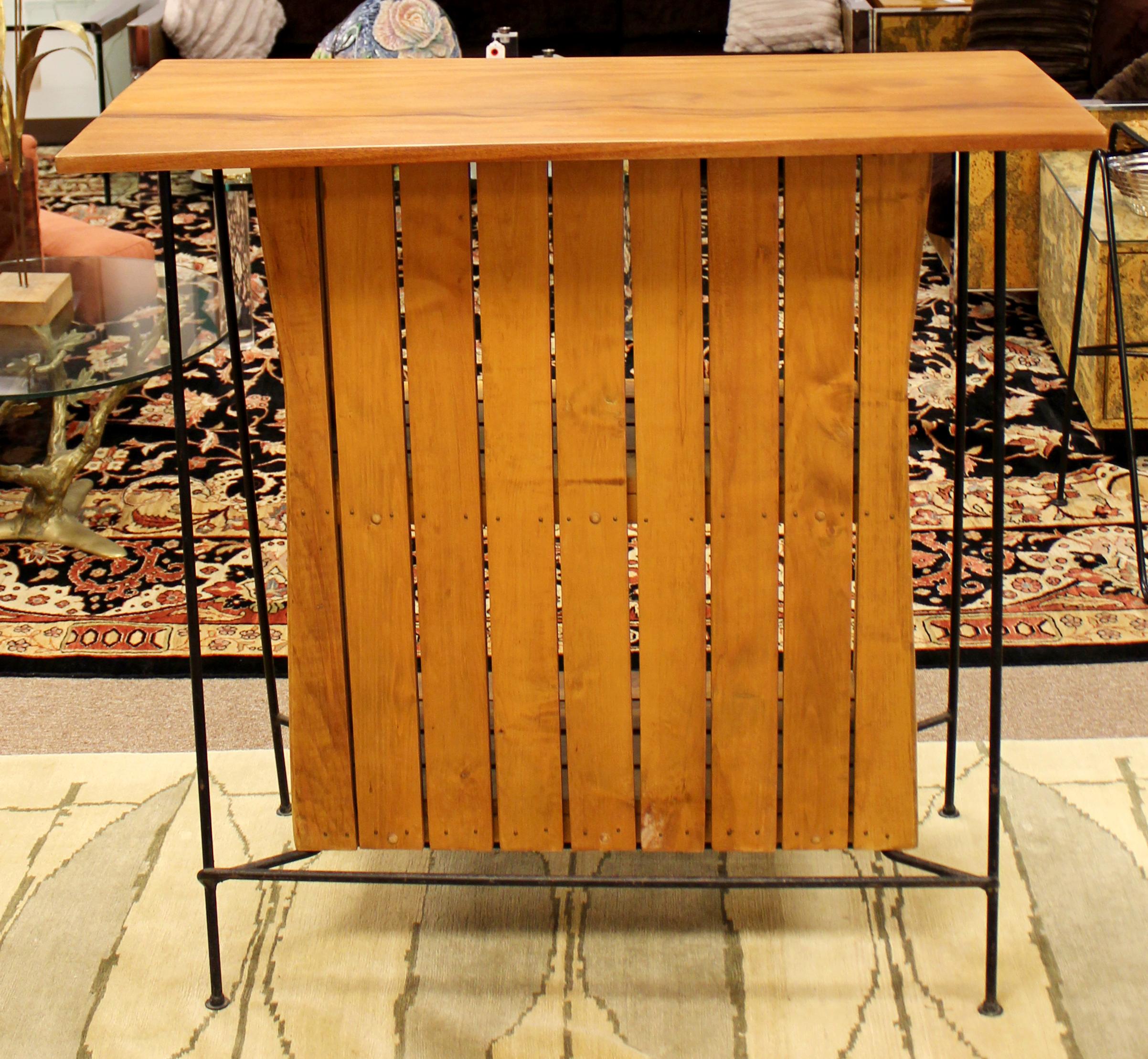 For your consideration is a beautiful, standing bar, made of wrought iron and with wooden slats, by Arthur Umanoff for Raymor, circa 1950s. In great vintage condition. The dimensions are 42