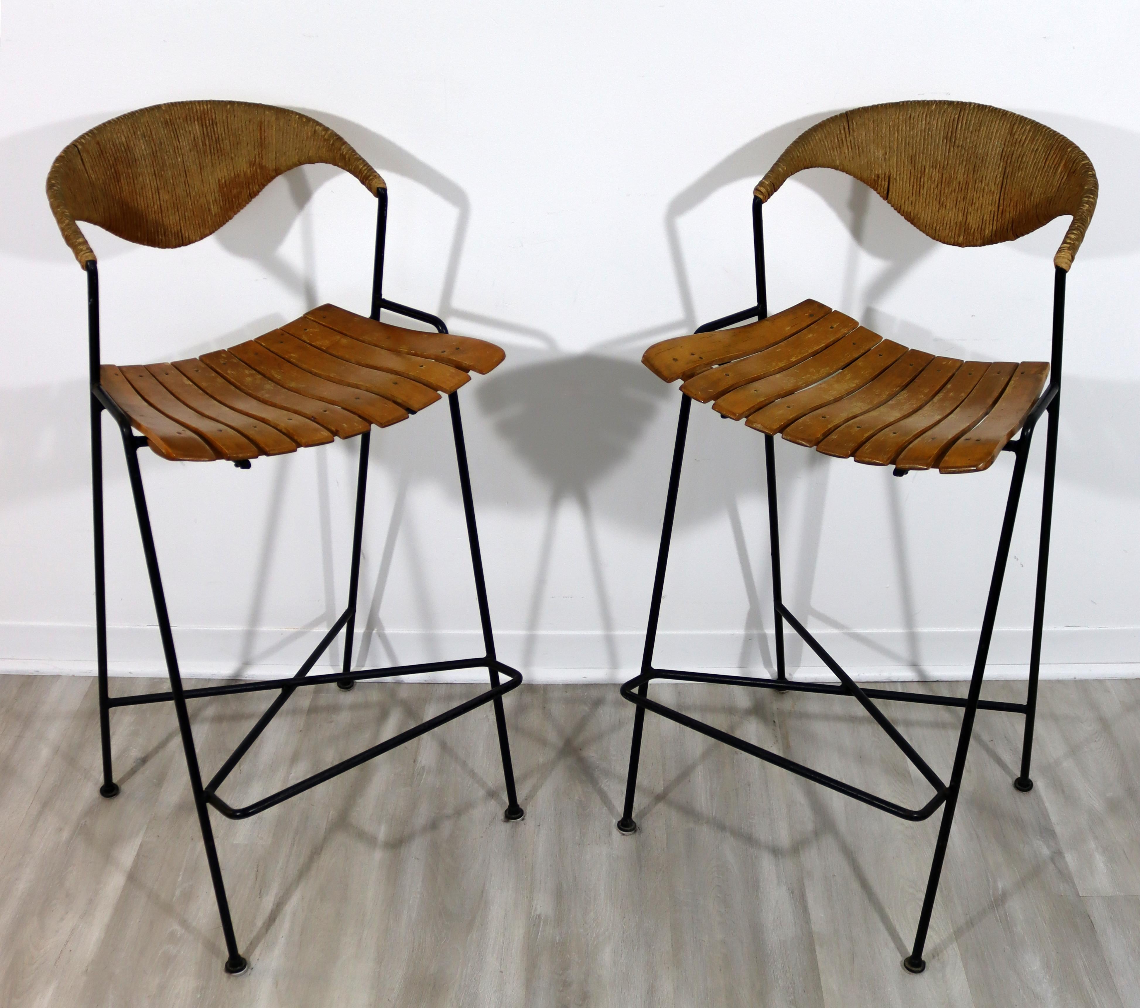 For your consideration is an outstanding pair of Arthur Umanoff, iron bar stools, with wood seats, circa the 1960s. In good vintage condition. The dimensions are 17
