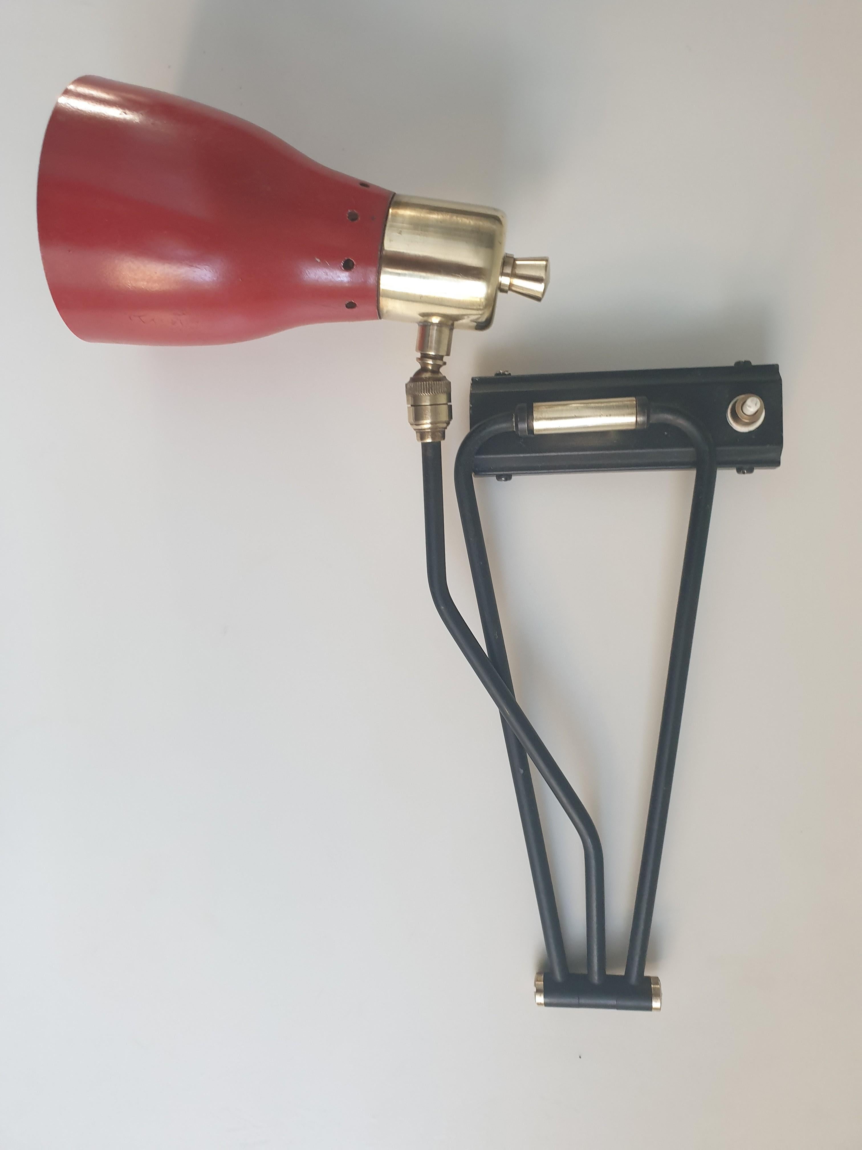 Simple industrial style wallight attributed to the well known Italian designer, Luigi Caccia Dominioni and probably made for Azucena. The red aluminium shade has its original paint finish in good condition, unusual for a wallight of this age, as has
