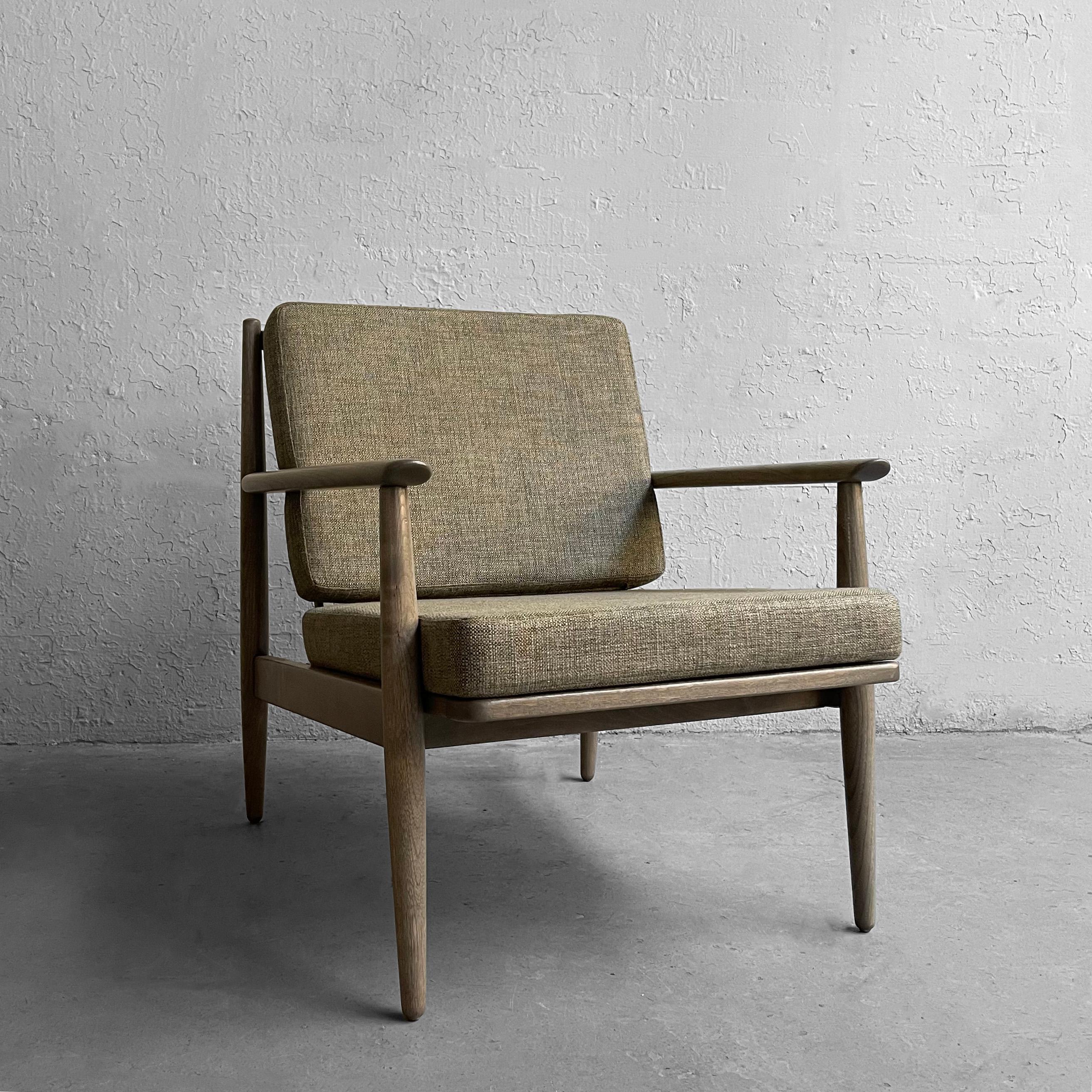 Mid-Century Modern, ash, lounge chair by Baumritter for their Viko collection features a custom pickle finish with newly upholstered cushions in light heather green, woven blend fabric. It's a fresh take on a Classic mid century profile.