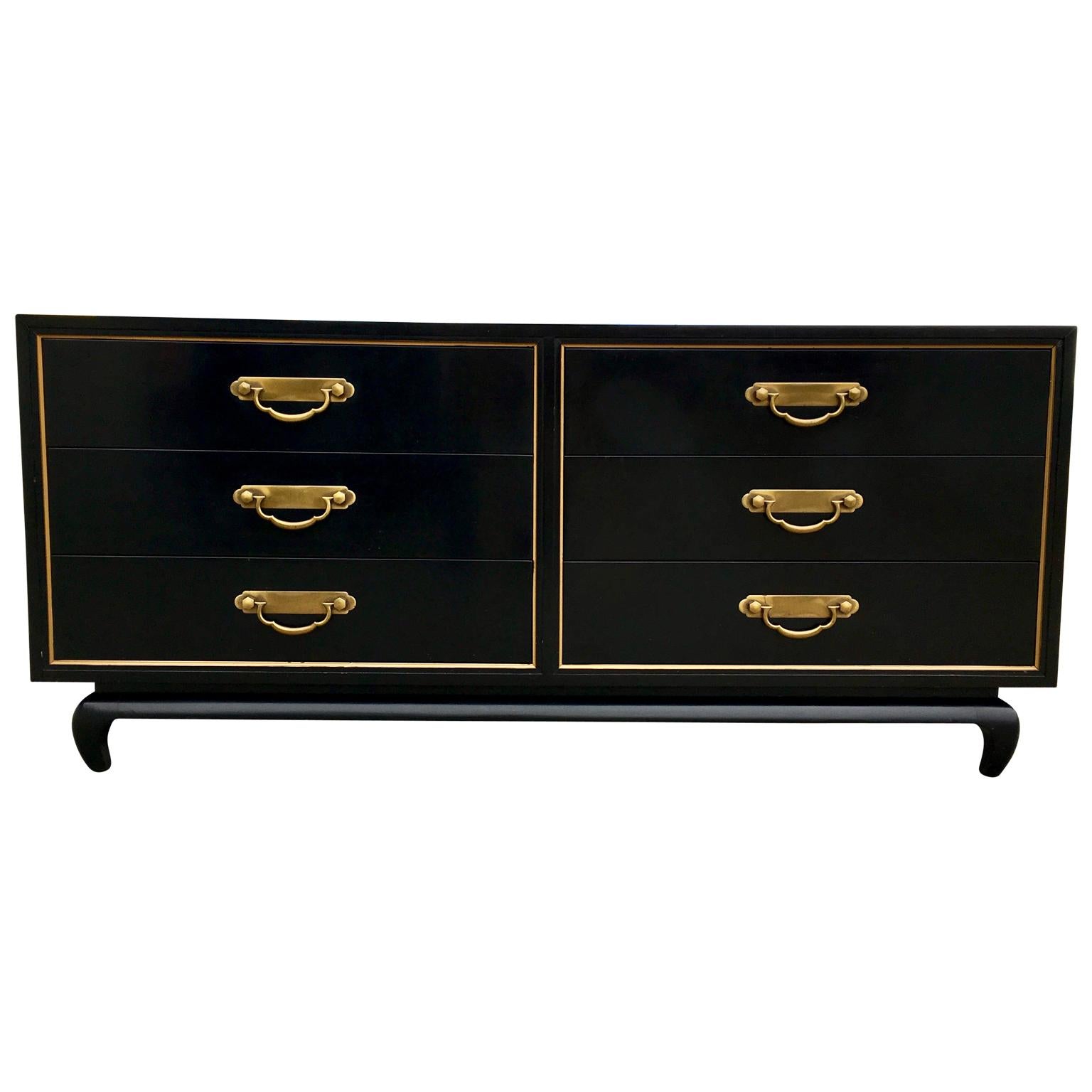 A exquisite black lacquered Mid-Century Modern Asian chest by American of Martinsville. Great design, nice large brass pulls. Original gold line detail. All original condition. Solid wood construction.