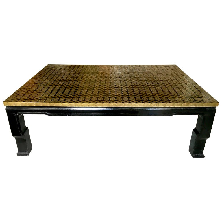 Midcentury Asian bronze coin coffee table black lacquered

A unique midcentury Asian bronze coin coffee table with black lacquer. The top is entirely covered in bronze Asian coins. Great design. Has brass trim. A makers mark stamped on bottom.