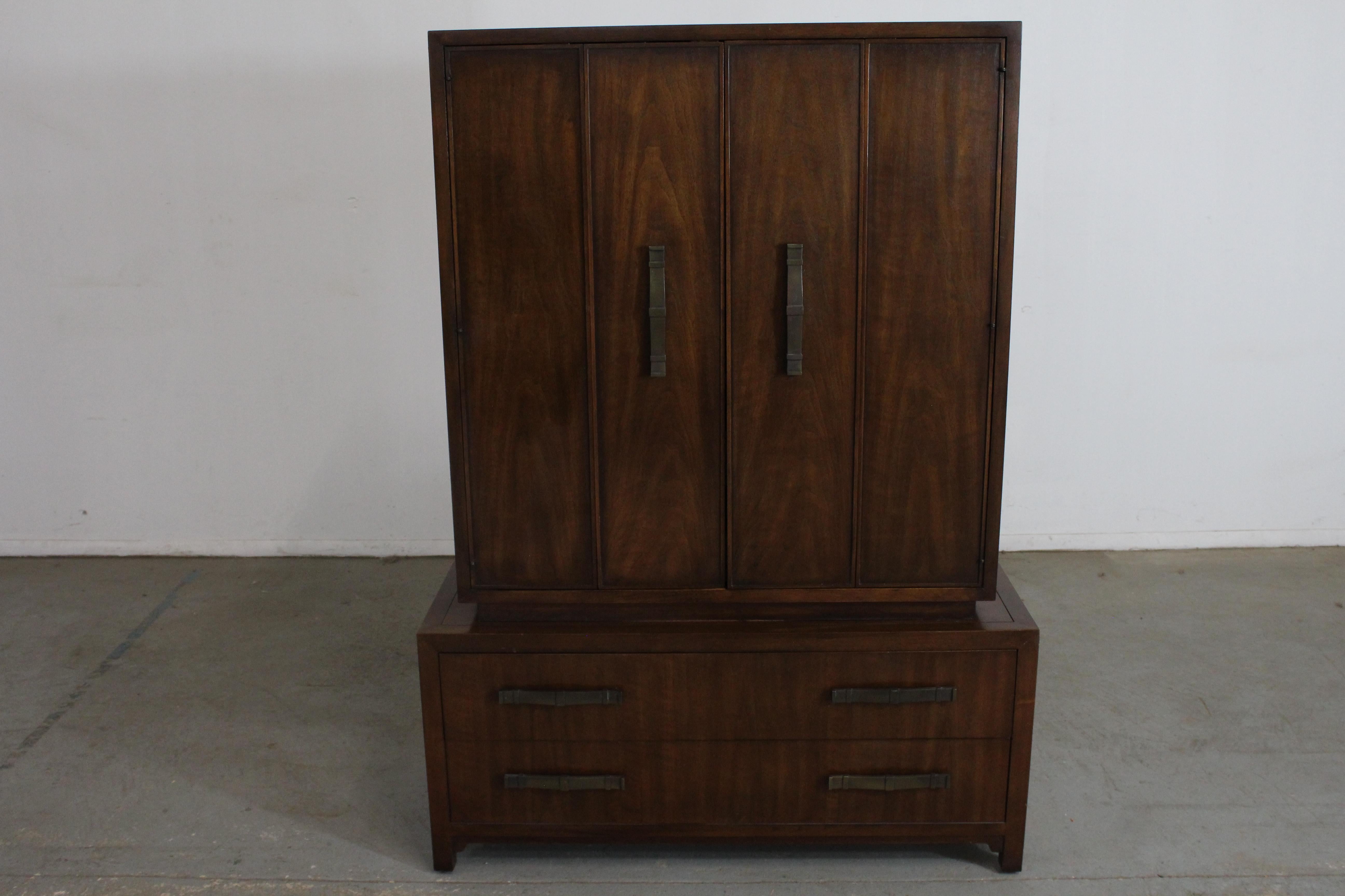Mid-Century Modern Asian Gentleman's Tall Chest on Chest by Heritage

Offered is an excellent example of Asian mid-century modern design; a Black Mahogany chest from the 1960's. Features a Chest on Chest with 2 drawers on the bottom. The top section