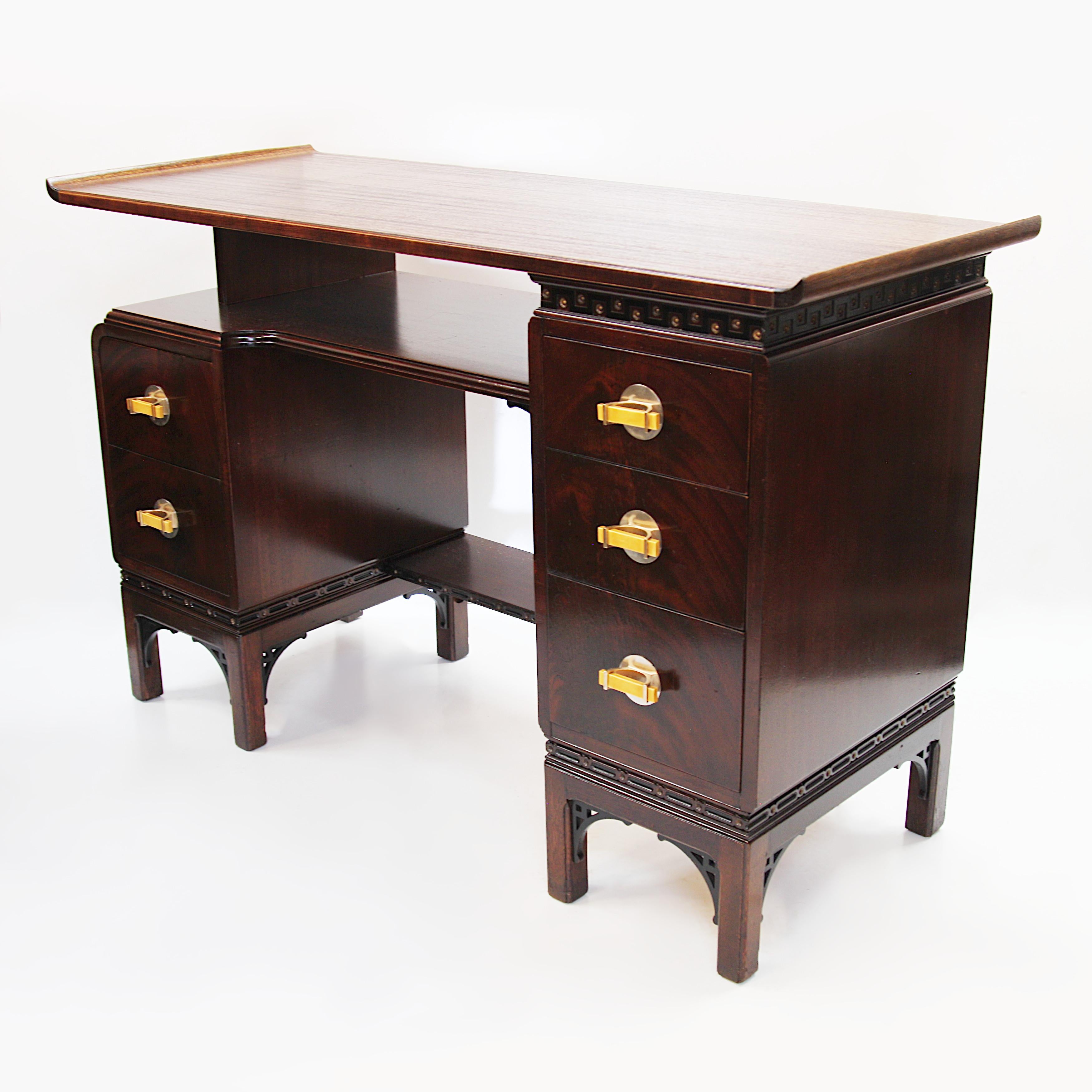 Rare pagoda writing desk by The Northern Furniture Company /Rway. Desk features a floating, pagoda-inspired top, unique Bakelite/silver drawer pulls, and a myriad of Asian influenced design features. With its versatile size and interesting design,