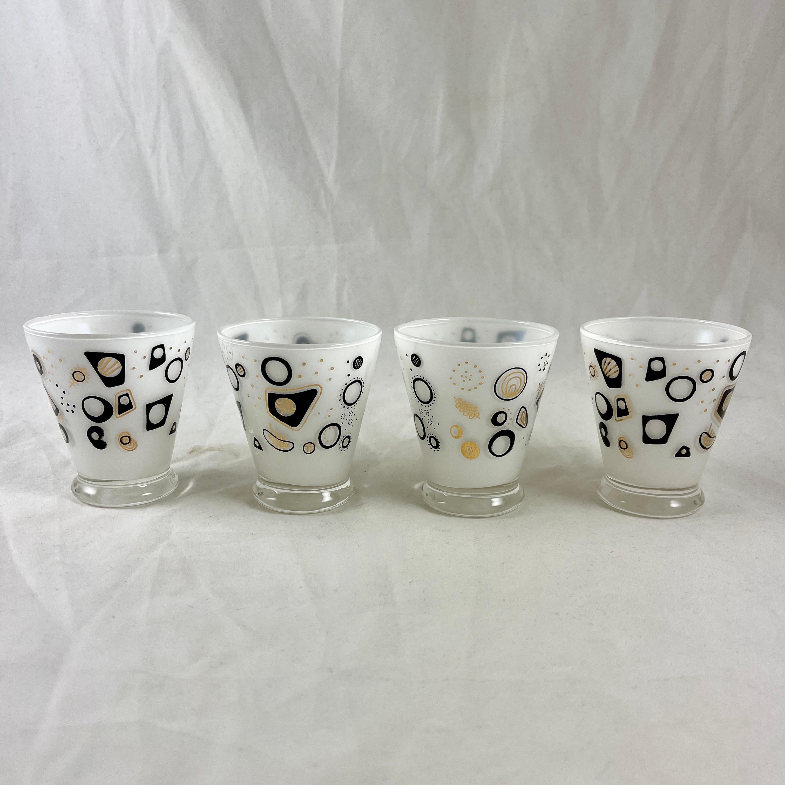 Mid-Century Modern rocks glasses in an Atomic pattern, circa mid 1950 - early 1960s.

A fabulous, fun set of four Mad Men Era Atomic rocks glasses, frosted on the interior in an opaque white. The pattern shows a variety of Atomic related shapes in