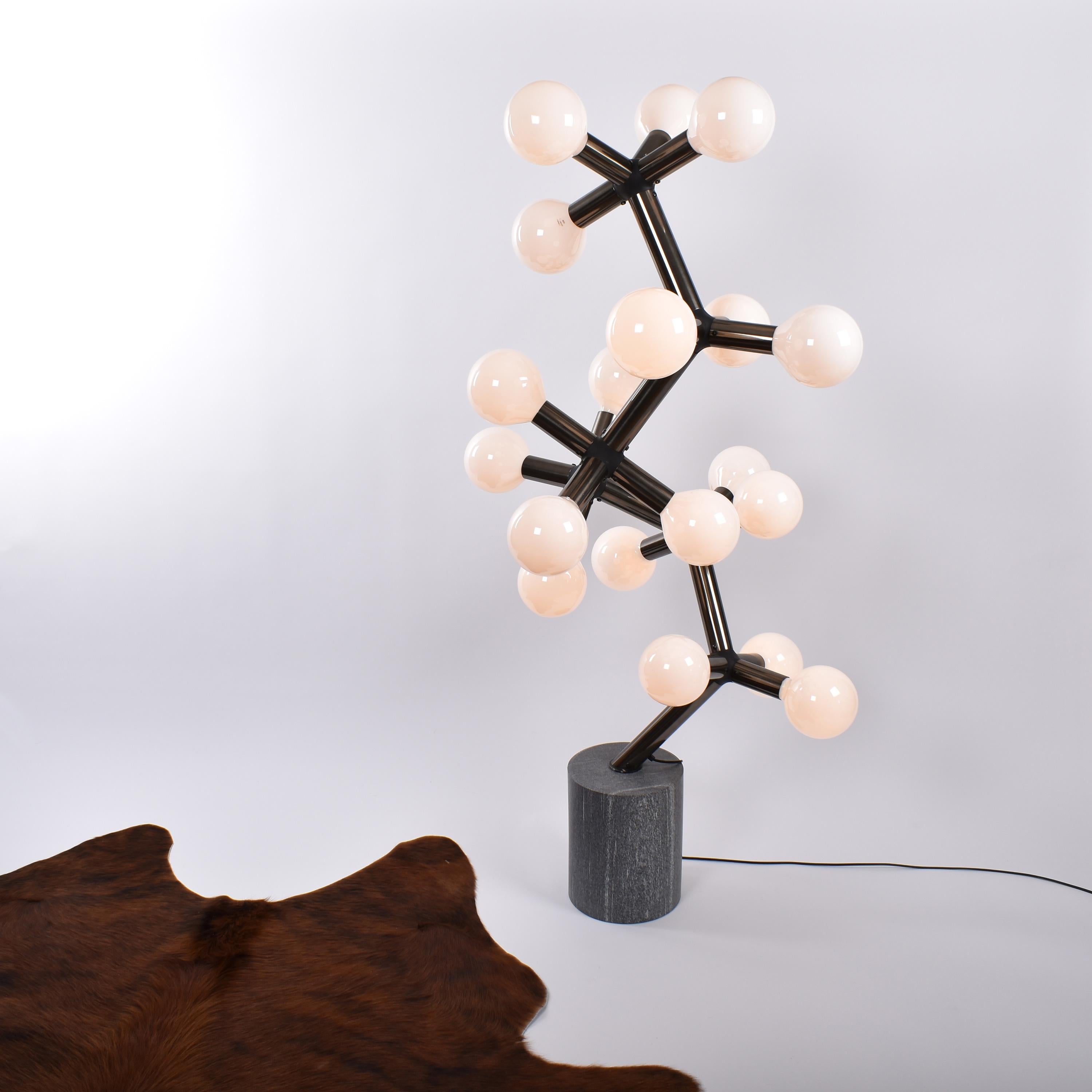 Exceptional Atomic floor lamp, designed by Trix and Robert Haussmann for Swisslamps international.
The molecular structure, made of bronzed aluminium, holds nineteen bulbs. 
It is inserted in a cylindric granite foot.
The whole piece shows