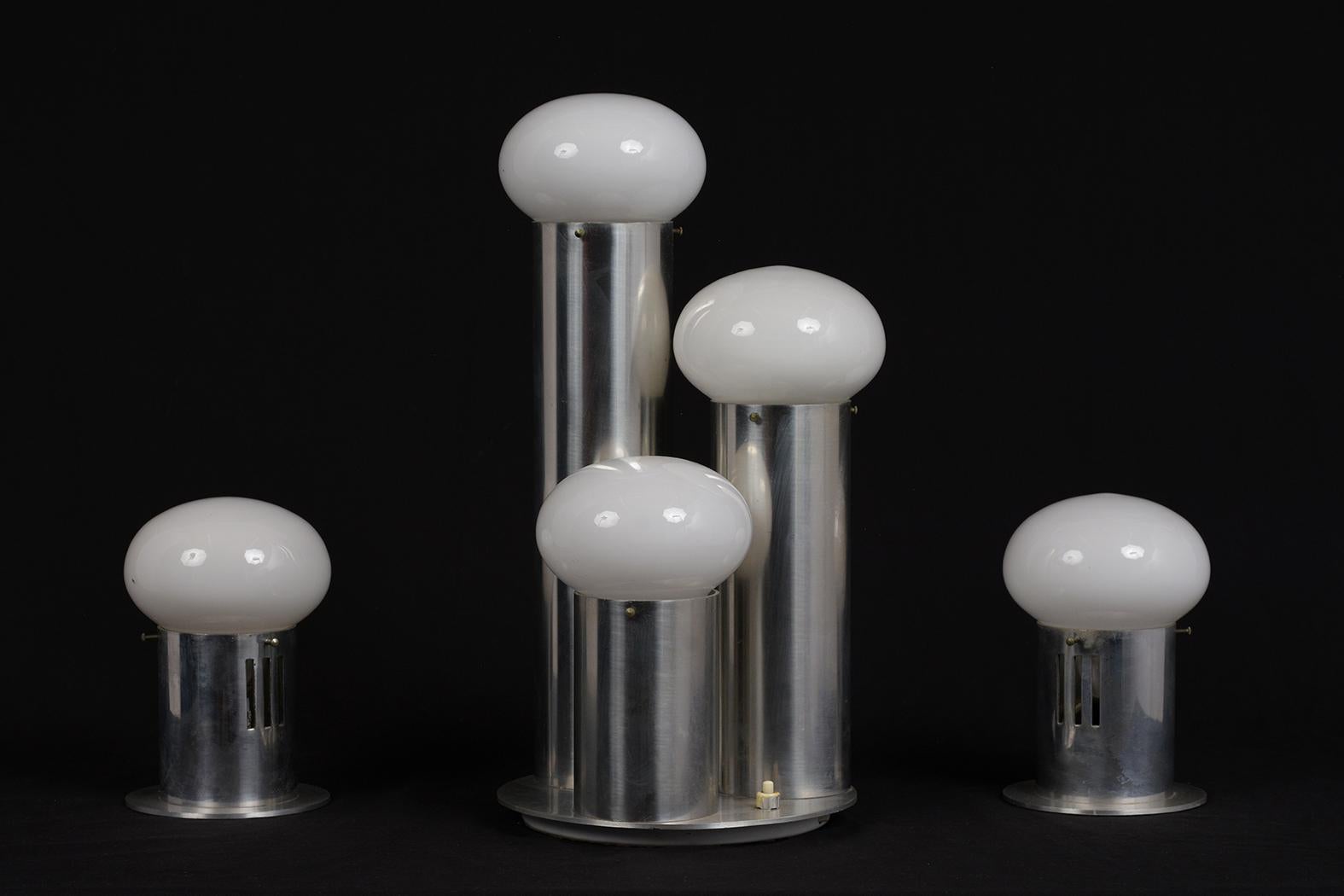 This 1960s modern Atomic style table lamps features a chrome base with decorative white bulbs. The set comes with a center three bulb lamp, and two single bulb lamps. The rods extend upwards at different lengths in a circular pattern, each rising