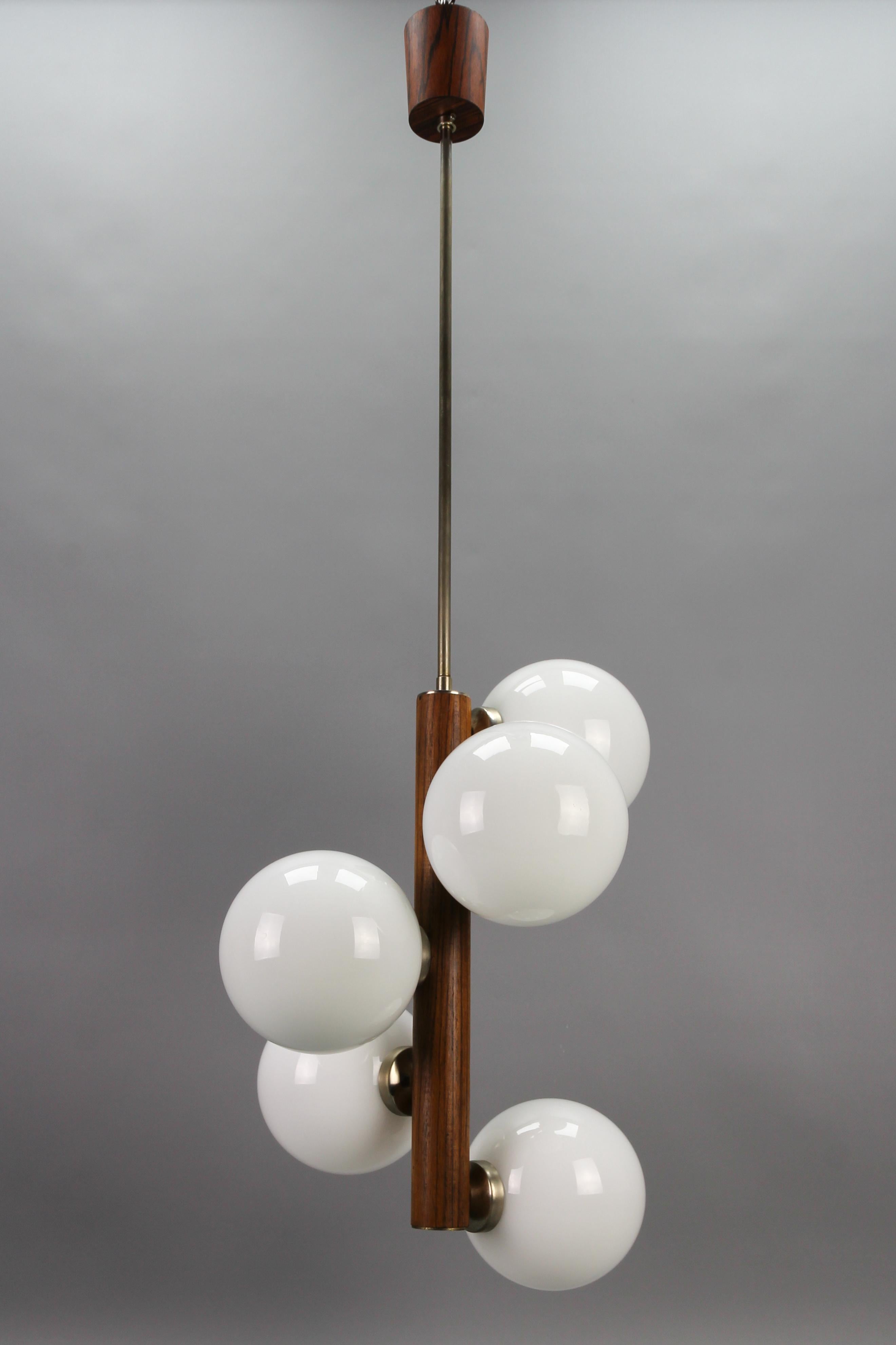 Mid-Century Modern Atomic White Glass Globes Five-Light pendant lamp
This adorable Mid-Century Space Age pendant light fixture features five cascade-aligned white glass globes. 
Five sockets for E14-size light bulbs.
Dimensions: height: 100 cm /