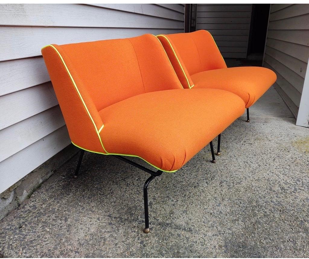 Exceptionally designed Mid-Century Modern chairs attributed to Clifford Pascoe.
Newly upholstered with orange Knoll fabric. These Space Age chairs feature brass ball glides, 
a painted black base and high end fabric and piping. Not to be missed.