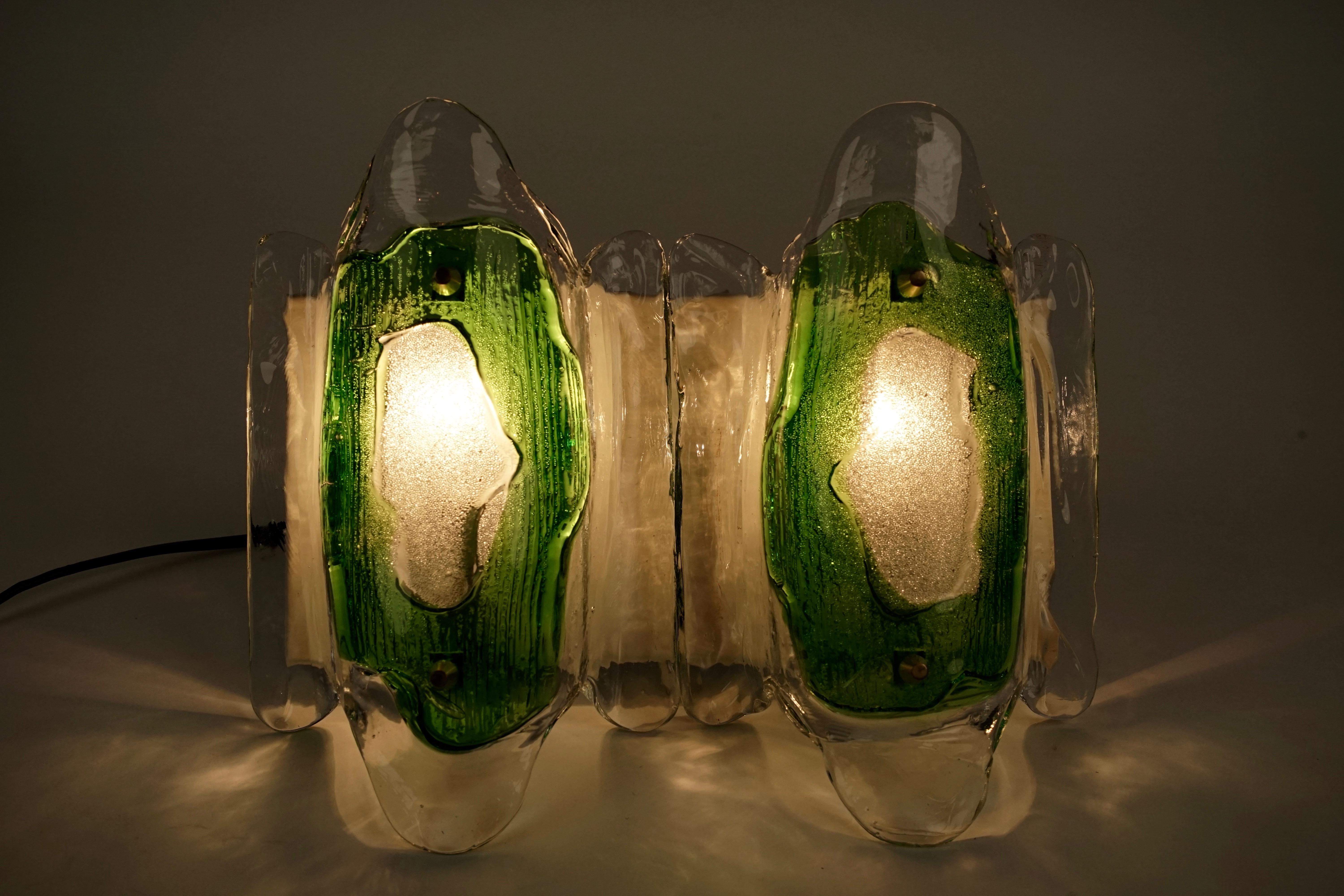 midcentury, modern, Austrian Glass wall lights manufactured at the end of the 1960s, beginning 1970s. The glass has been individually formed by Slumping in the oven to create unique bi-colored green and clear glass elements. The glass was produced