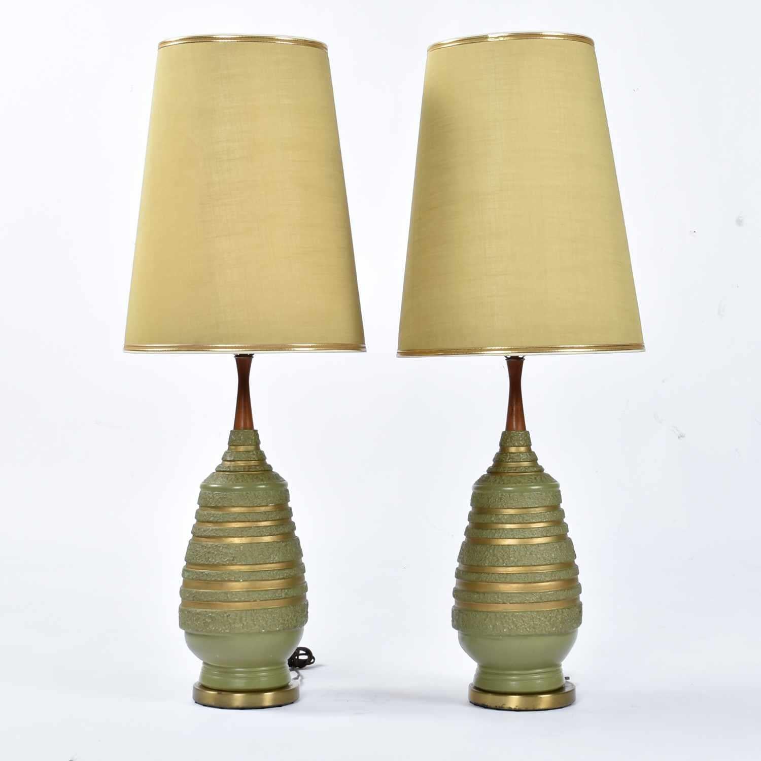 Incredible complete pair of Mid-Century Modern avacado green lamps by Plasto. These have got to be some of the most authentic Mid-Century lamps around. It is quite rare to find lamps with their original shades. These green, conical shades are