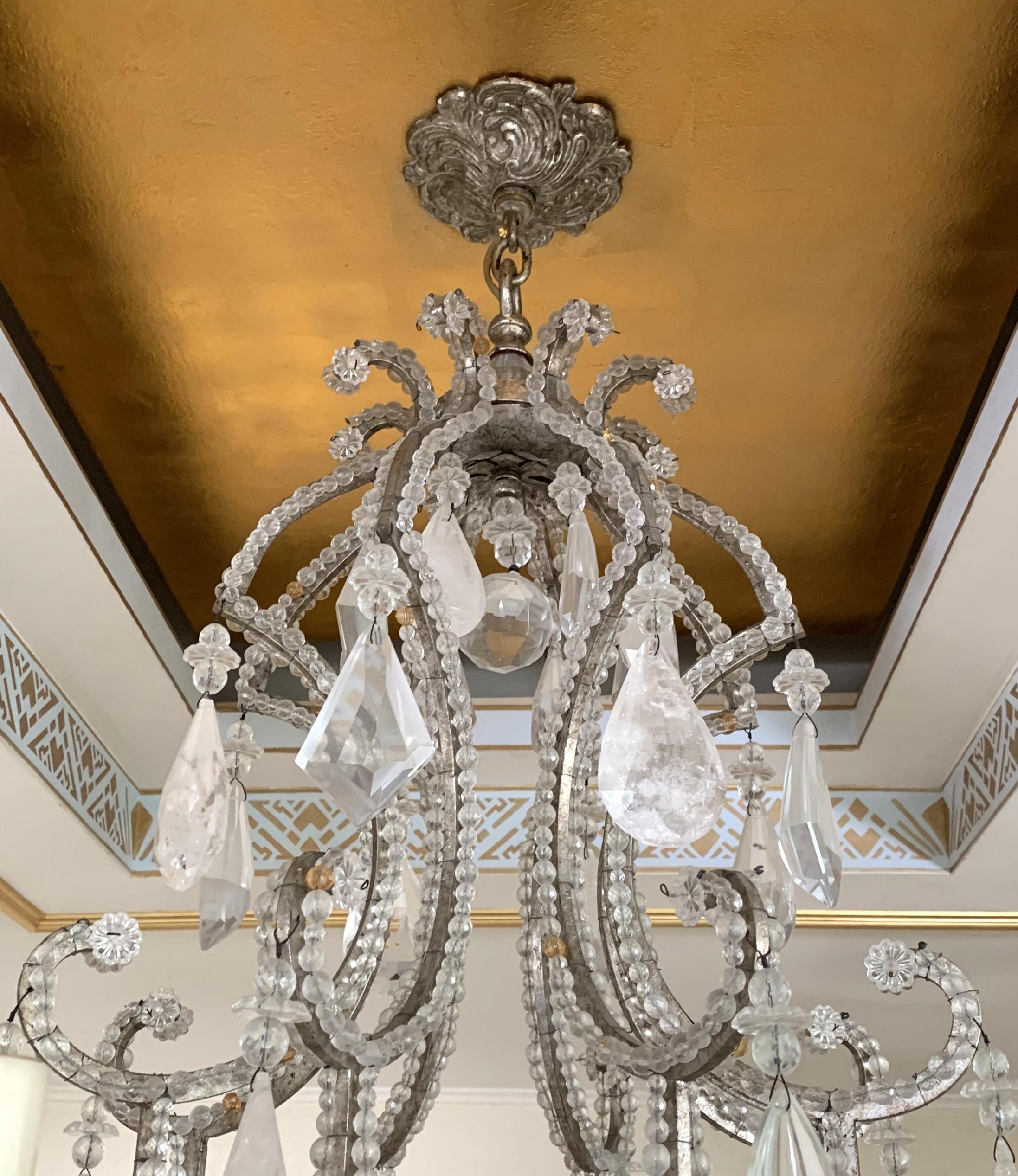 A wonderful Mid-Century Modern Baguès style silver and gold gilt beaded rock crystal large 8-light chandelier with center crystal obelisk finial.