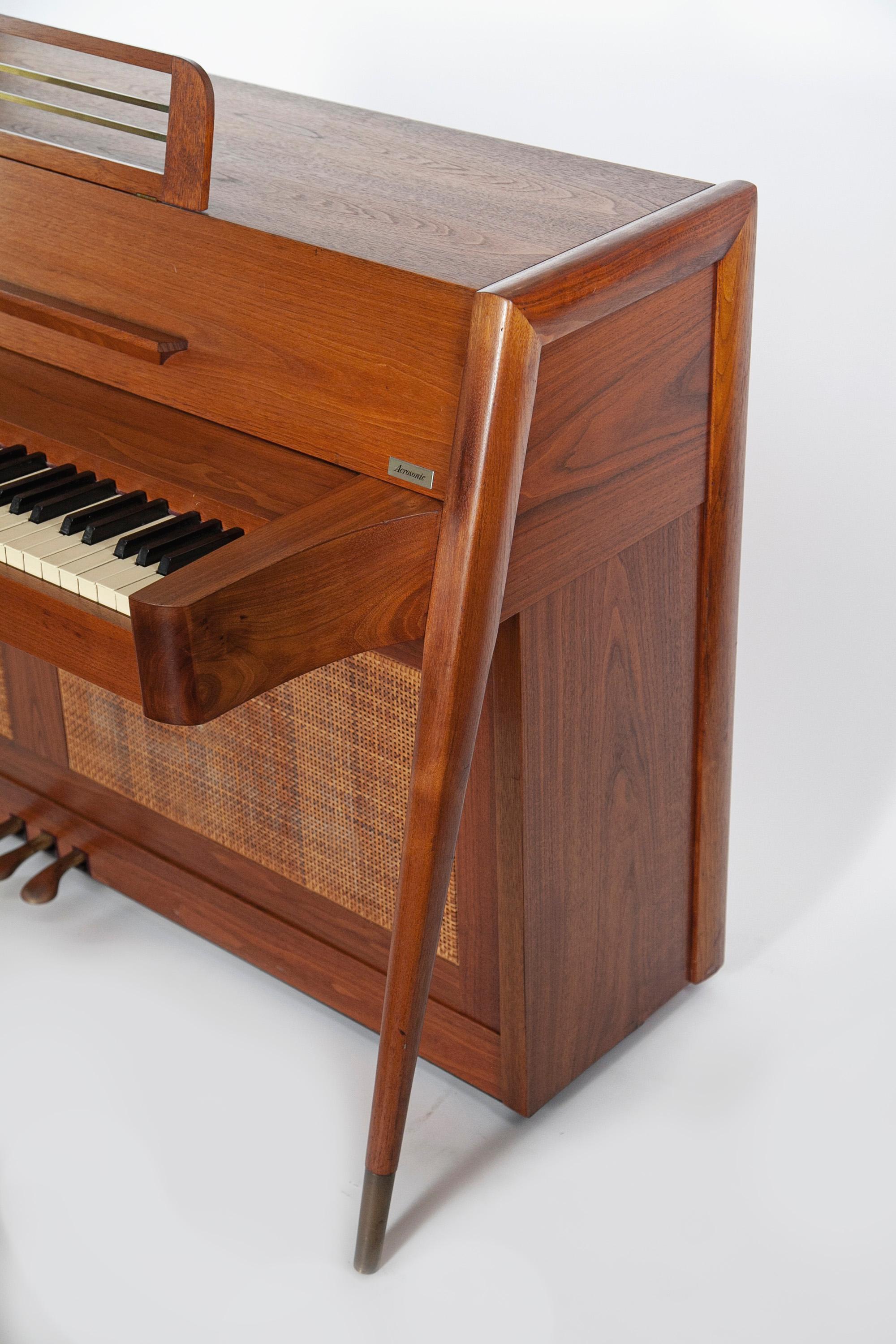 Mid-Century Modern Baldwin Acrosonic Piano in Walnut and Caning - 1960's

This Mid-Century modern Acrosonic spinet piano made by Baldwin is very sought after and is an amazing addition to any home. It's signature Danish style modern tapered leg
