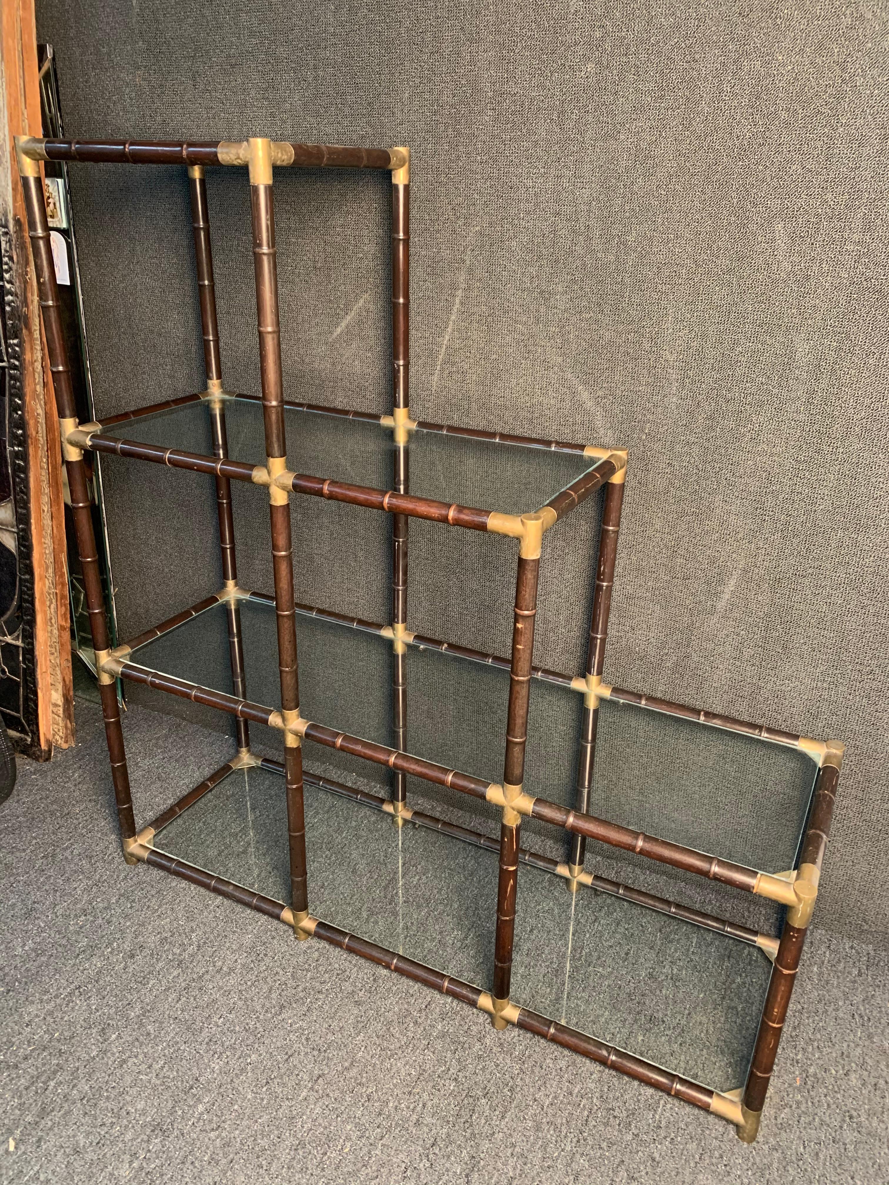 Mid-Century Modern Bamboo and Brass Etagere. This piece features faux bamboo styling, brass accent corners, and (4) glass shelves. A perfect piece if you are in need of accent shelving.
