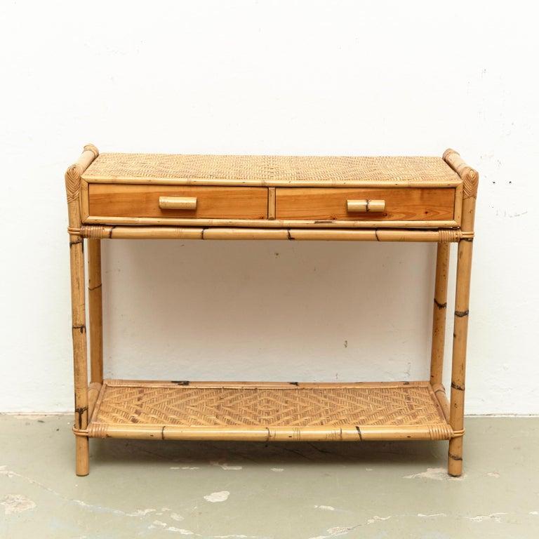 Mid-Century Modern bamboo and rattan console, circa 1960
Traditionally manufactured in France.
By unknown designer.

In original condition with minor wear consistent of age and use, preserving a beautiful patina.