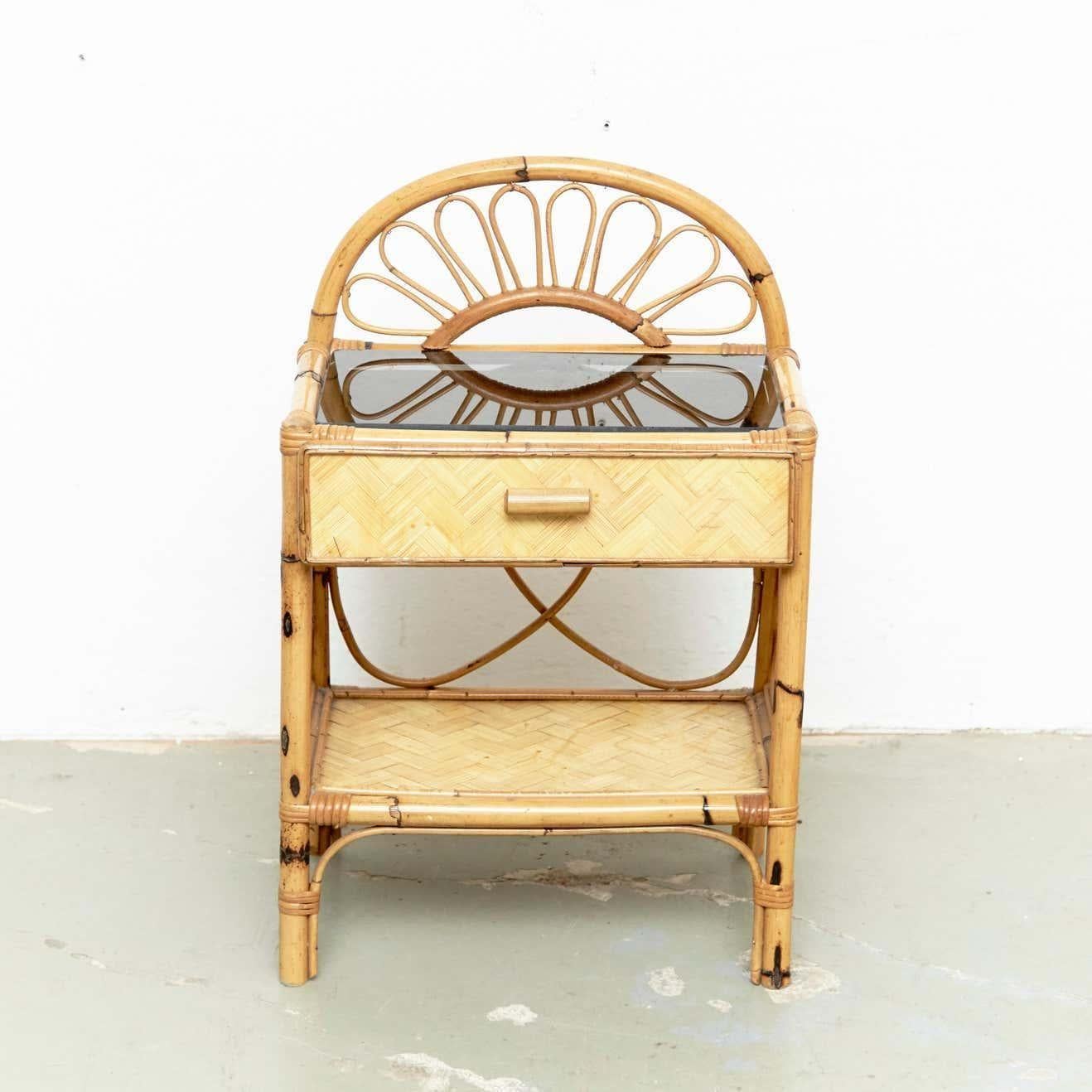 Mid-Century Modern bamboo and rattan side table with glass, circa 1960
Traditionally manufactured in France.
By unknown designer.

In original condition with minor wear consistent of age and use, preserving a beautiful patina.