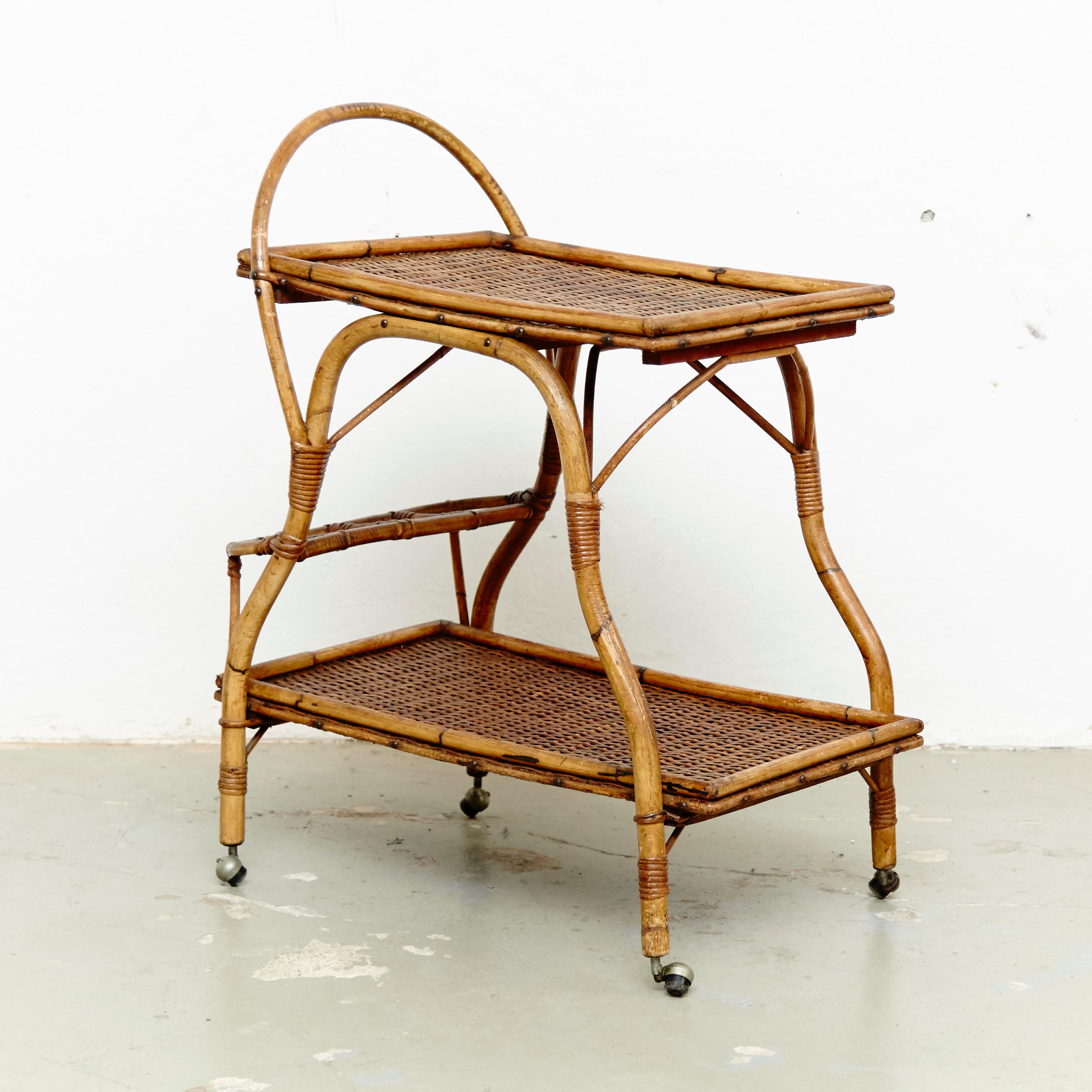 Mid-Century Modern bamboo and rattan trolley, circa 1960
Traditionally manufactured in France.
By unknown designer.

In original condition with minor wear consistent of age and use, preserving a beautiful patina.

 