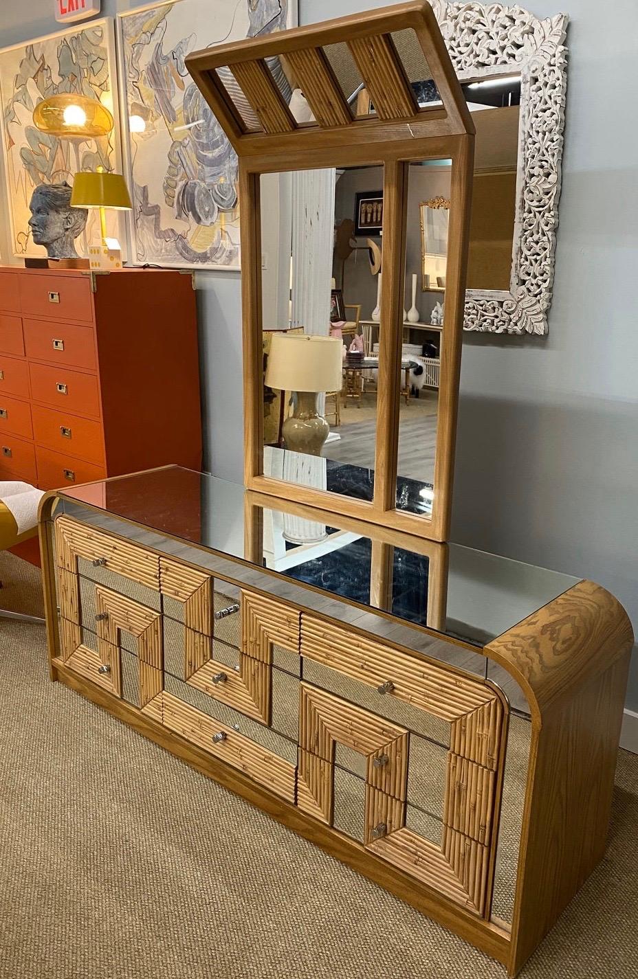 Stunning midcentury bamboo, wood and chrome chest of drawers that has matching mirror. Dimensions of the dresser are below and the mirror measures 30