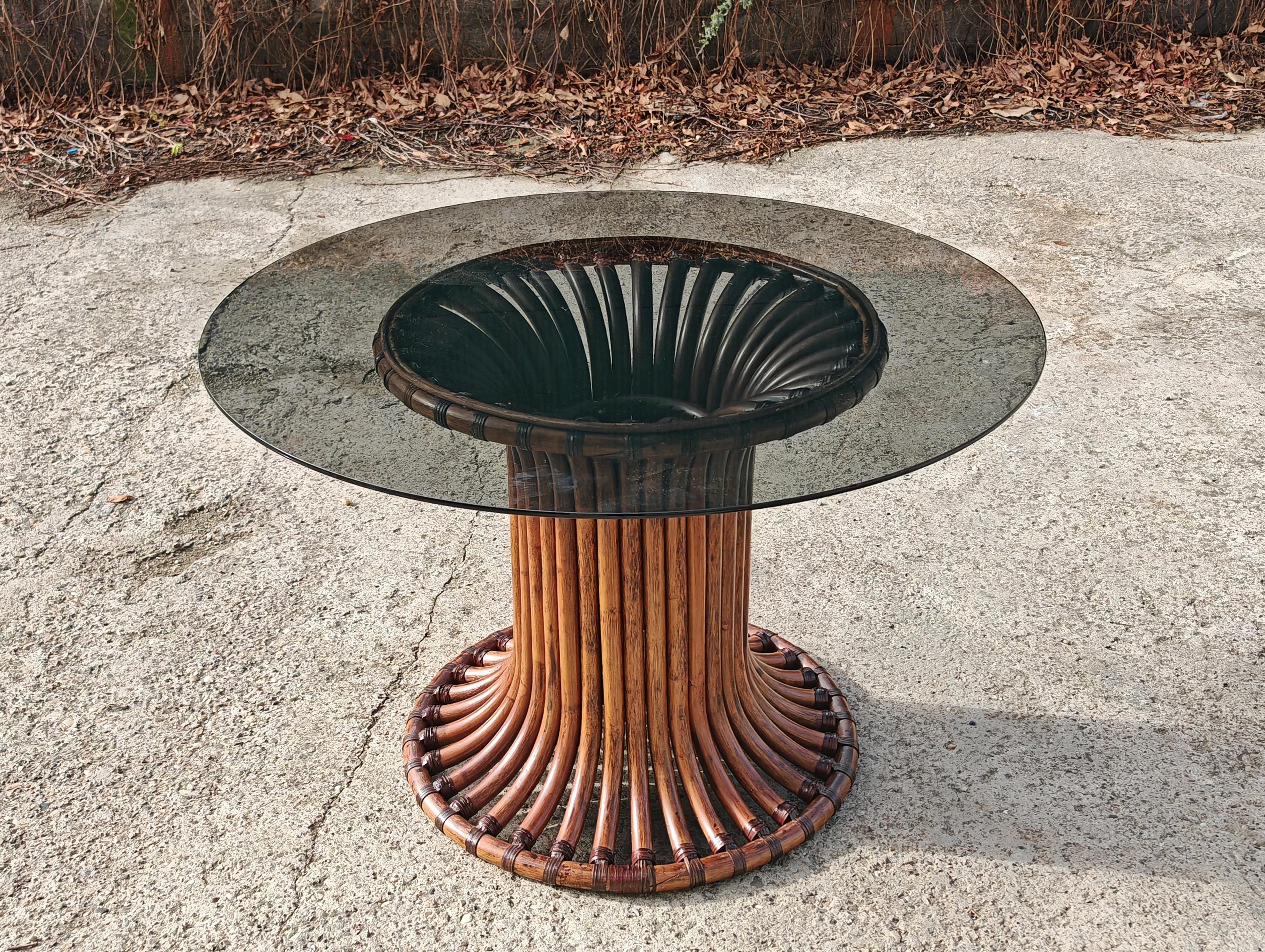 In this listing you will find gorgeous Mid Century Modern Dining Table attr. to Vittorio Bonacina. It features a beautiful base done in bamboo in a slightly darker, walnut stain and the round smoked glass top. The table was made in Italy in the