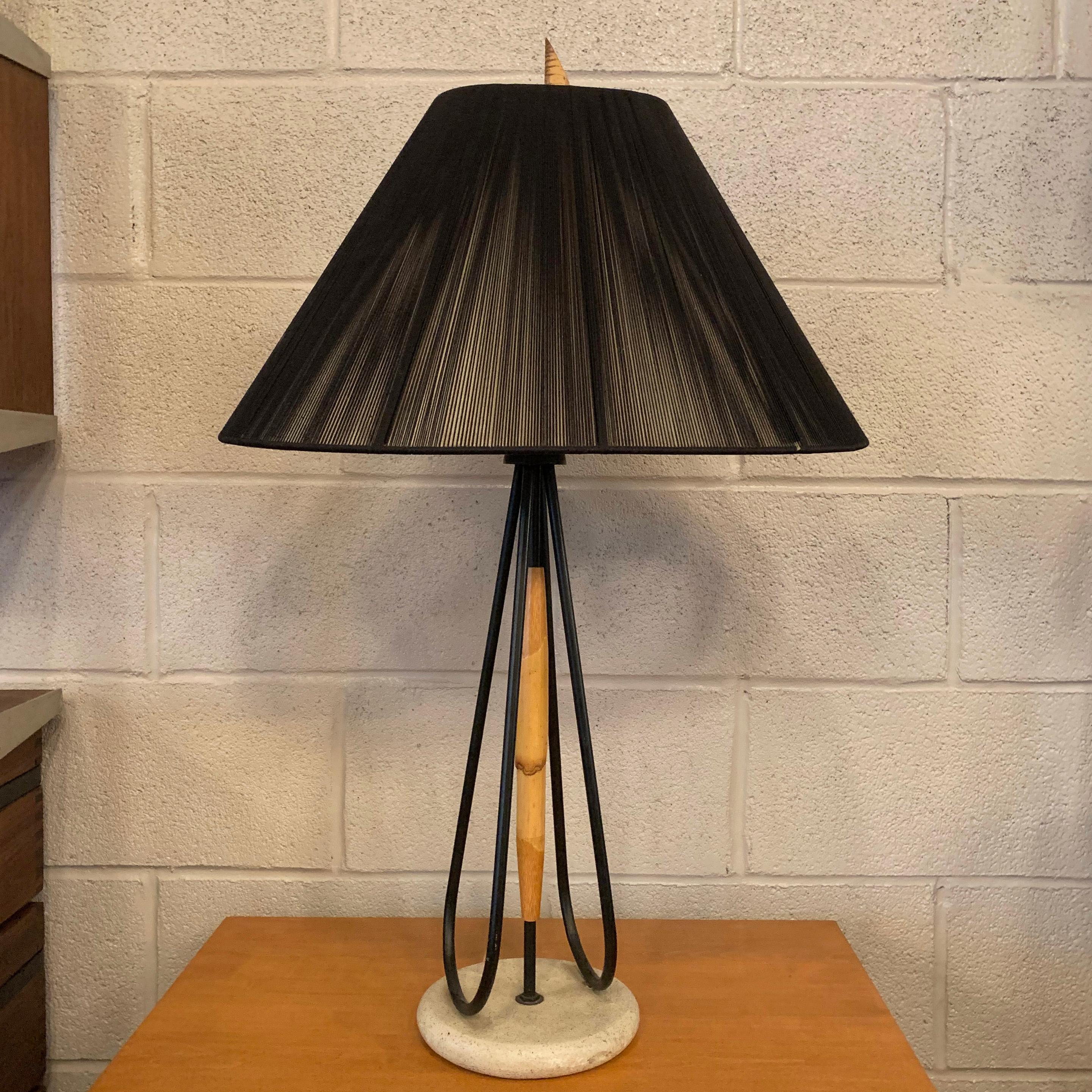Mid-Century Modern table lamp features a delicate wrought iron and bamboo stem on a painted wood base with black silk string shade by Hilo Steiner and matching bamboo finial.