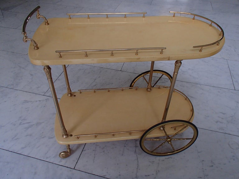 Mid-Century Modern bar cart by Aldo Tura vanilla goat skin and brass in very good condition.
  