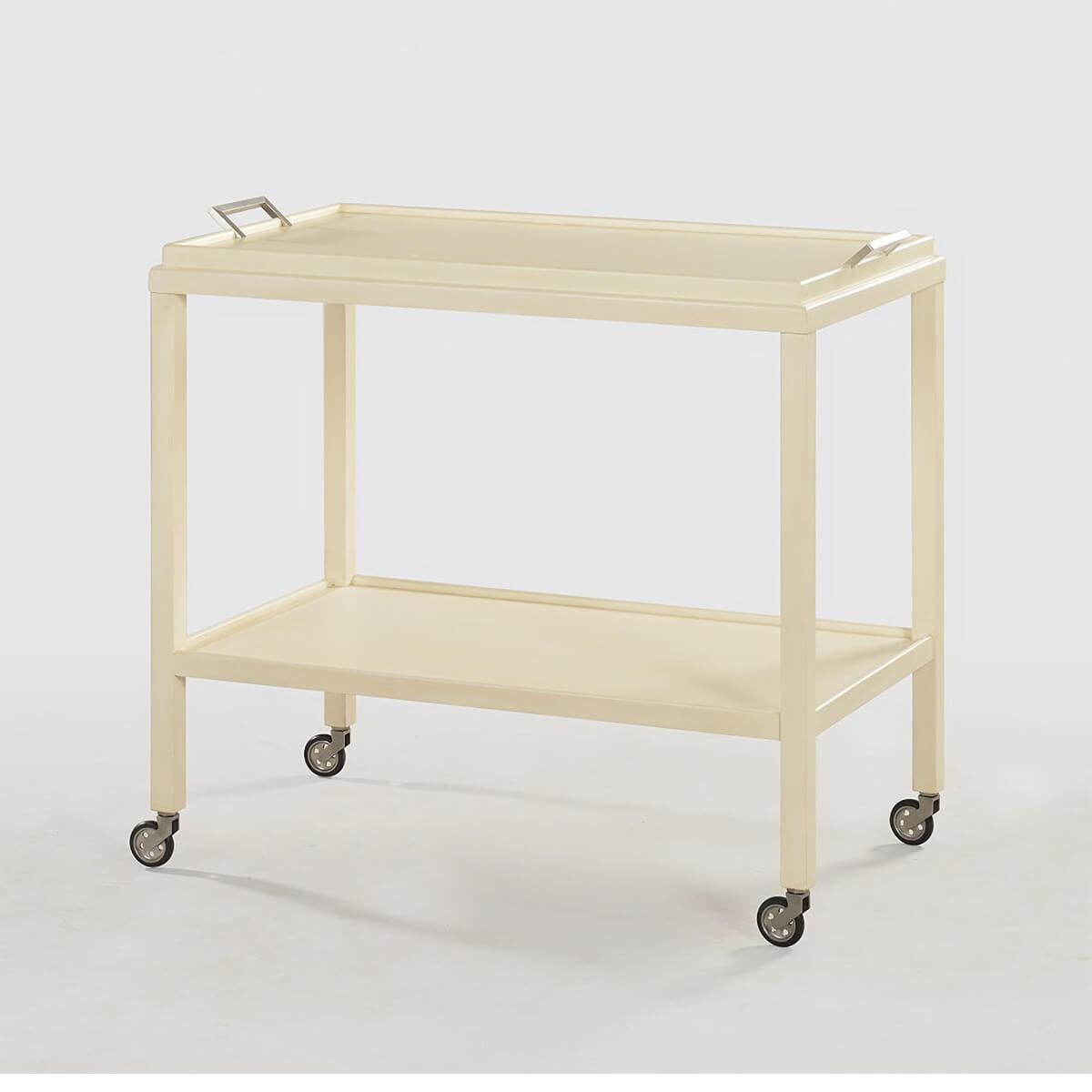 Mid-Century Modern bar cart with removable tray and shelf has hand-cast brass hardware and brass wheels with floor protective tread and a “coconut” painted finish with slight glazing on acacia veneer and acacia solids.

Dimensions: 33