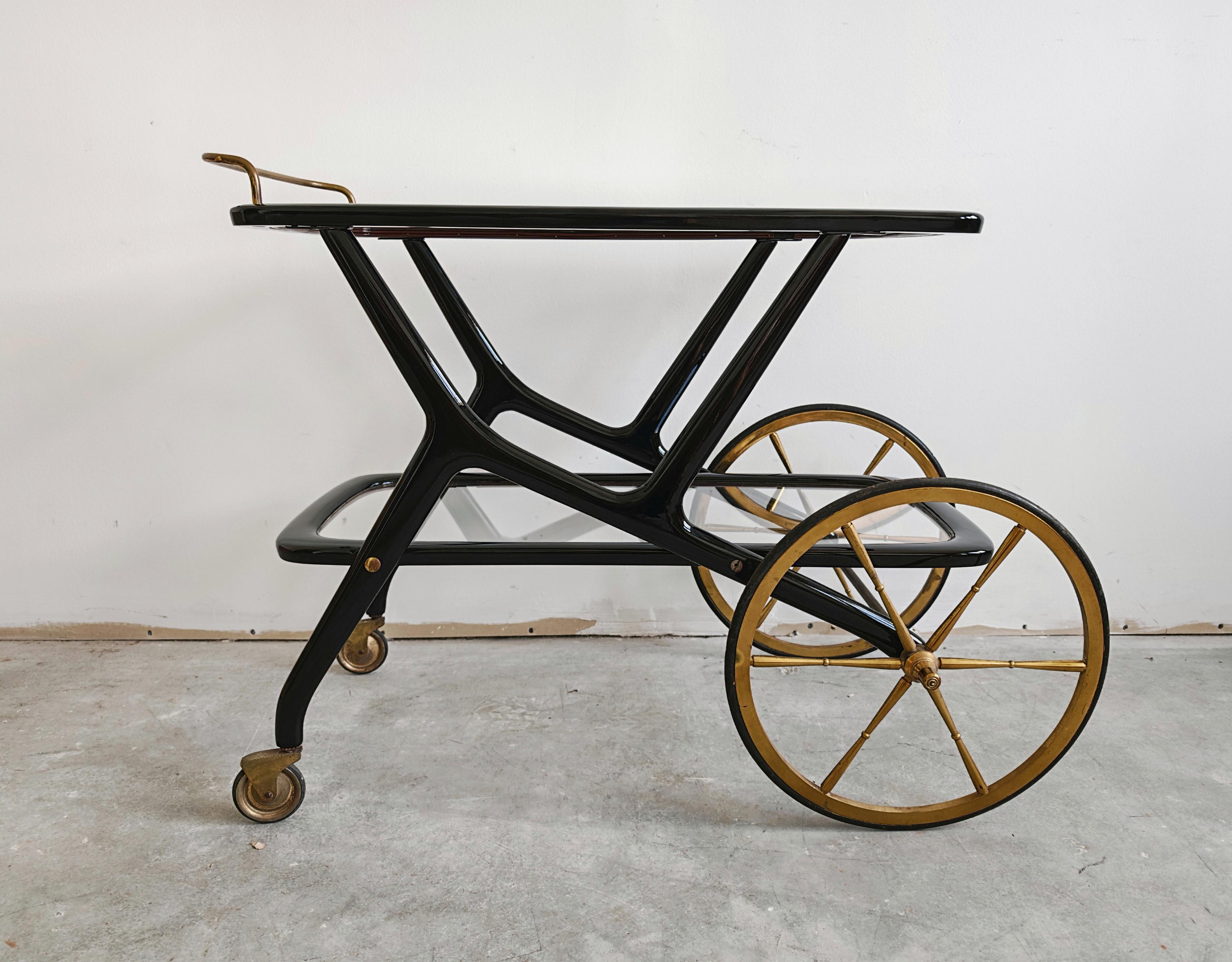In this listing you will find one of the Iconic designs of the Italian master Cesare Lacca. The small 2-tier Bar Cart features beautiful, elegant lines with its frame done in black lacquered beech, brass hardware and clear glass tops. Made in Italy