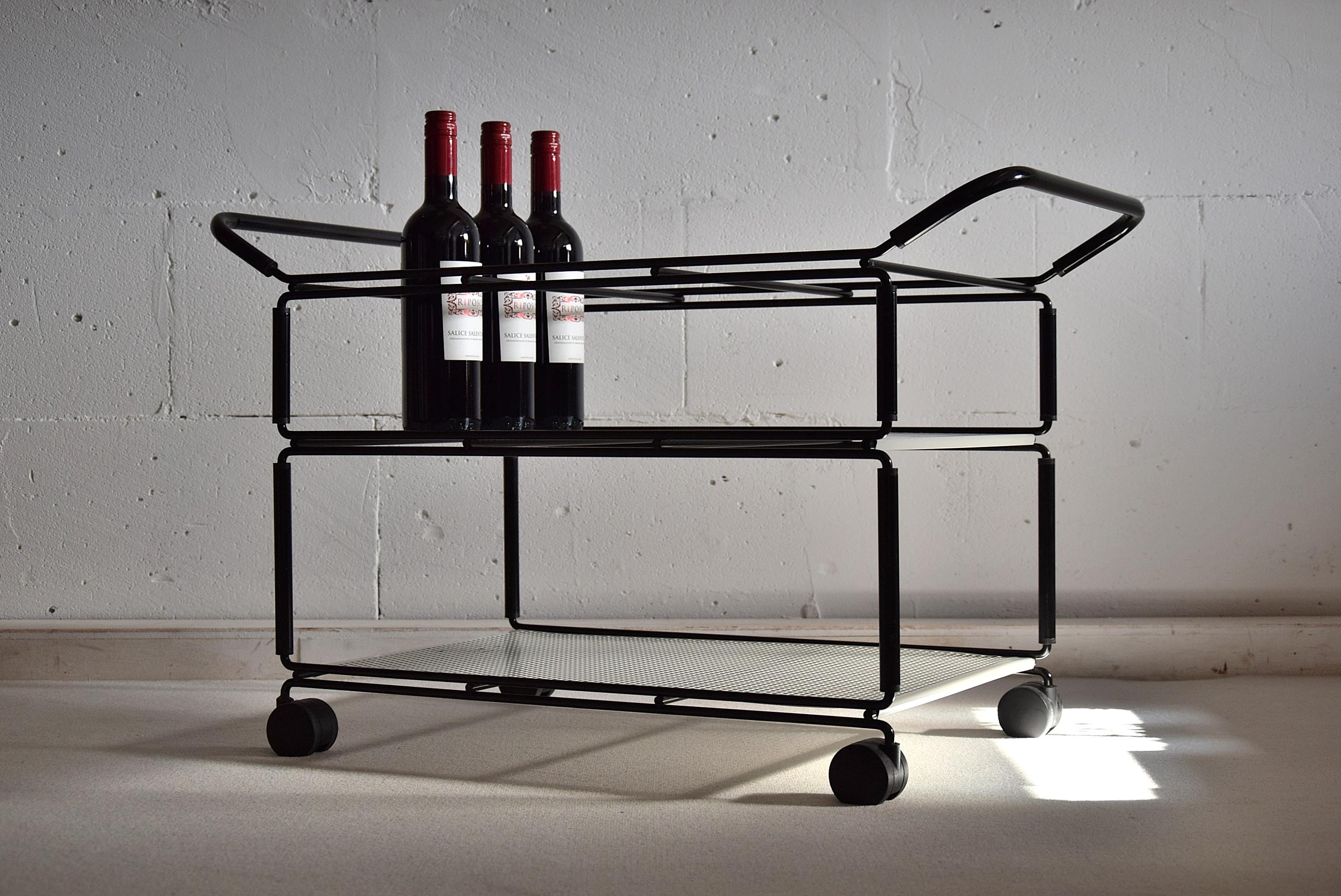Stylish and elegant mid century modern black and white bar trolley in the style of Mathieu Matégot, designed and made in the 1960s.

The top trier can be removed and placed in the centre as can be seen in the pictures.

The trolley is in good