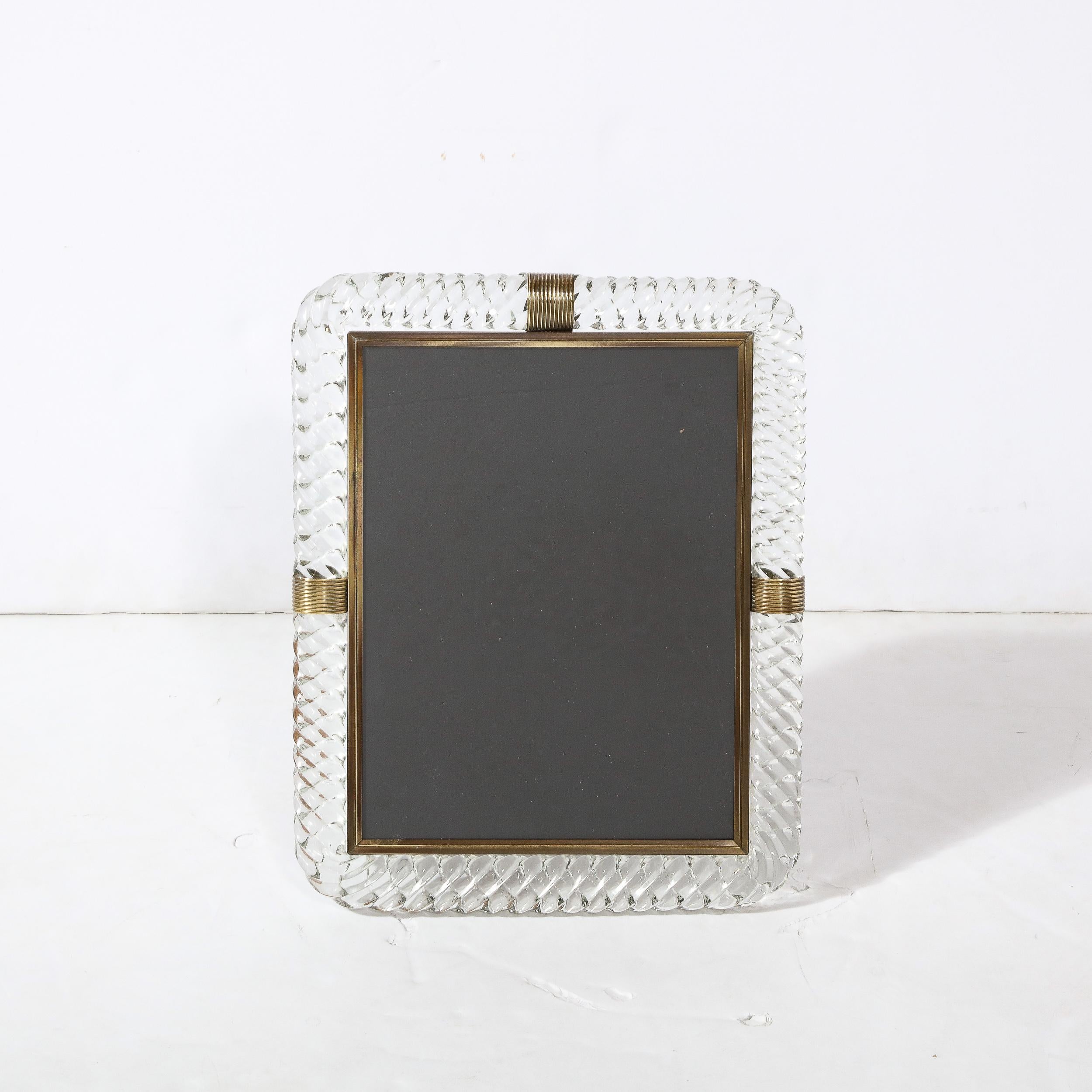 This stunning Mid-Century Modern picture frame was realized by the legendary atelier of Barovier e Toso in Murano, Italy circa 1960. It offers a rectangular form with rounded corners in Barovier's signature translucent braided glass offering a