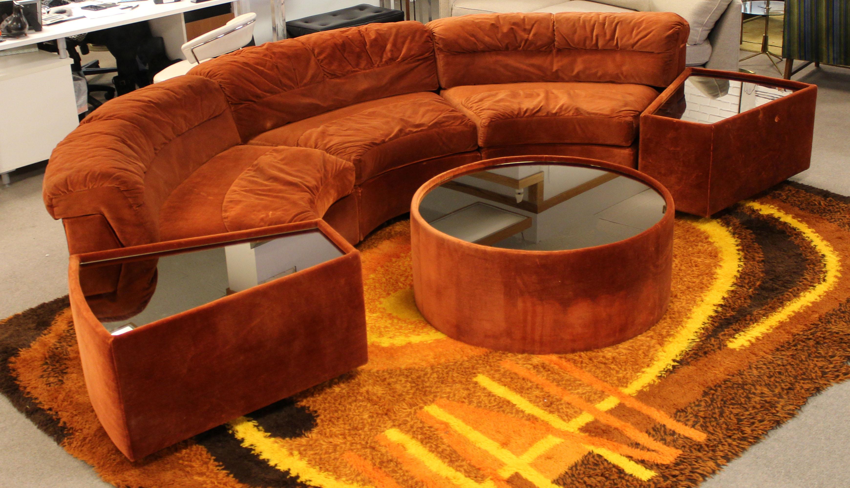 For your consideration is a magnificent, curved sectional sofa, with matching side and coffee tables that have smoked glass mirrored tops, by Charlton Company, circa the 1970. In good vintage condition, with scratches in the glass. The dimensions of