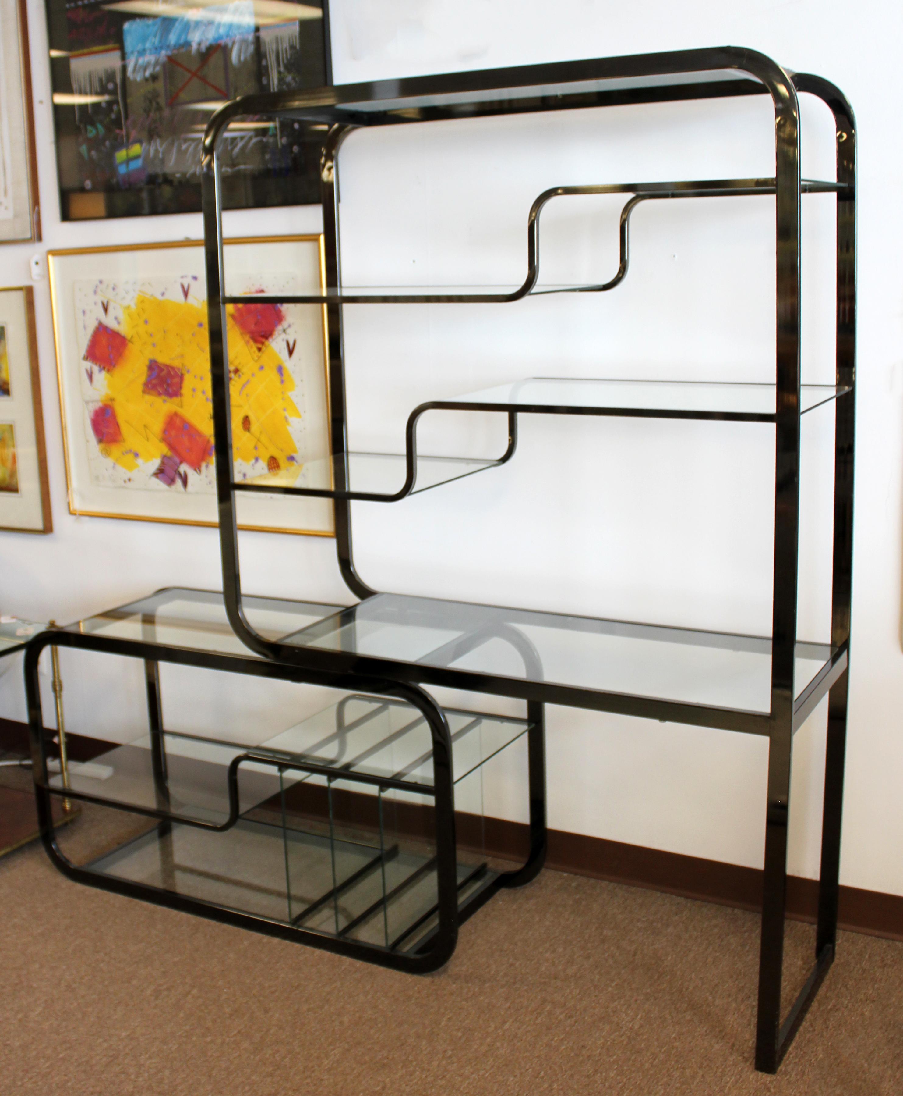 For your consideration is a magnificent, expandable, gunmetal shelving unit étagère, with glass shelves and sections, in the style of Milo Baughman, circa 1970s. In excellent vintage condition, with some surface scratches in the metal. The