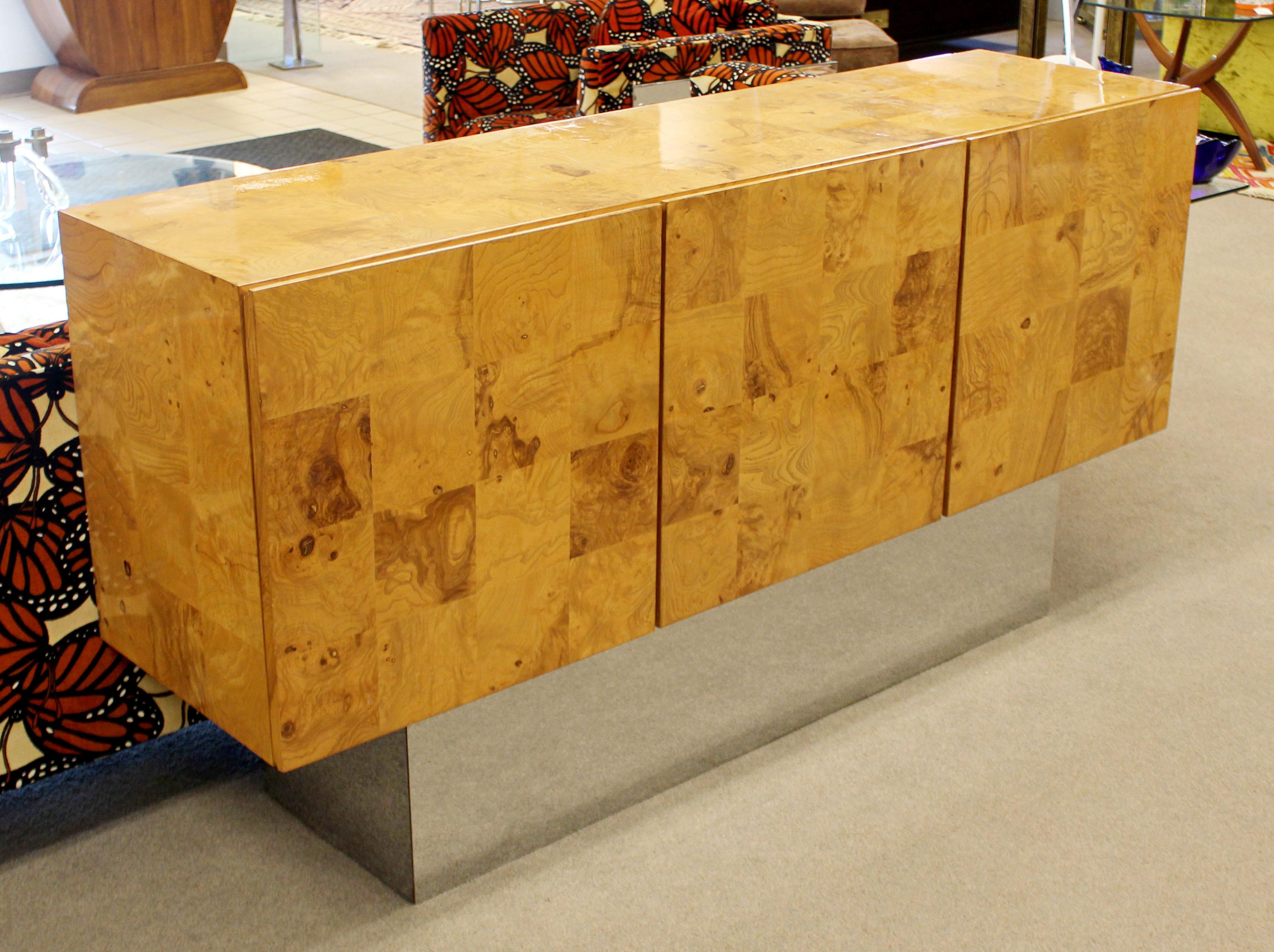 For your consideration is an exceptional, burl wood credenza, floating on a large chrome plinth base, by Milo Baughman for Thayer Coggin, circa 1970s. In excellent condition. The dimensions are 66